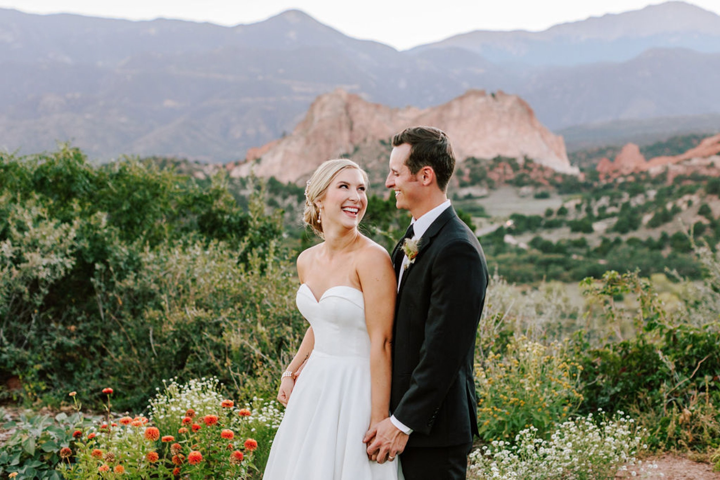 Bride and groom at Garden of the Gods with red rock formations in the background during their Colorado Springs wedding