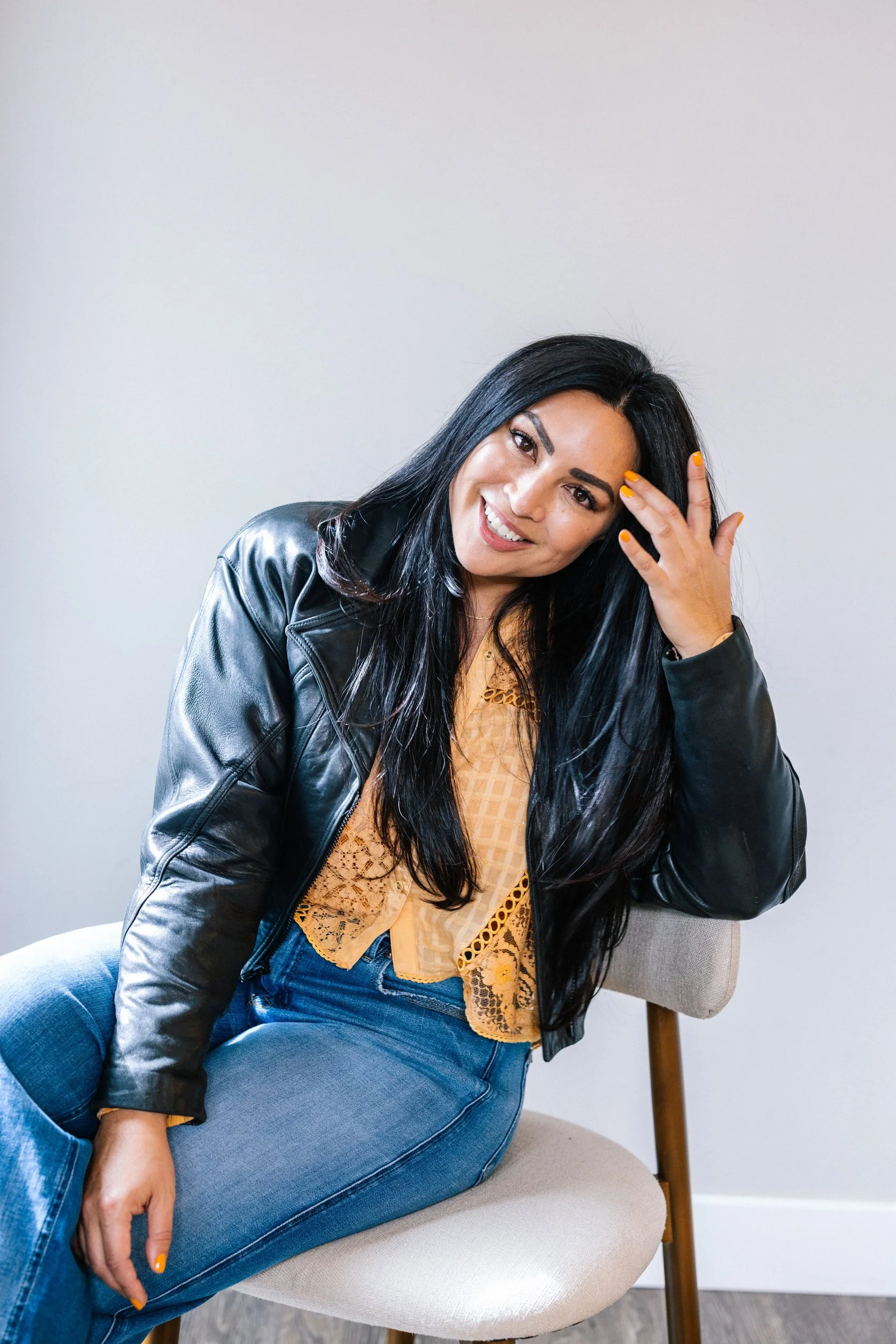 Editorial branding headshot of a woman in a leather jacket during a Denver portrait session by Betsi Ewing