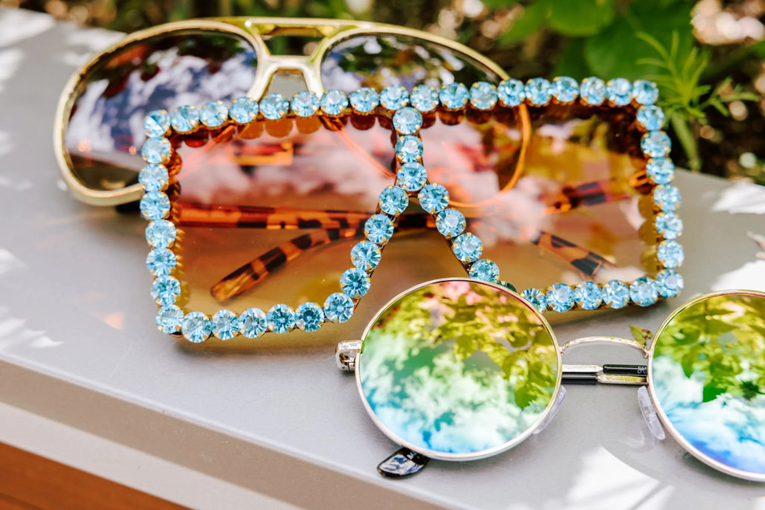 Oversized rhinestone sunglasses with blue crystal gems displayed as a wedding detail, rodeo disco bachelorette and wedding styling at Pine Creek Cookhouse Aspen Colorado