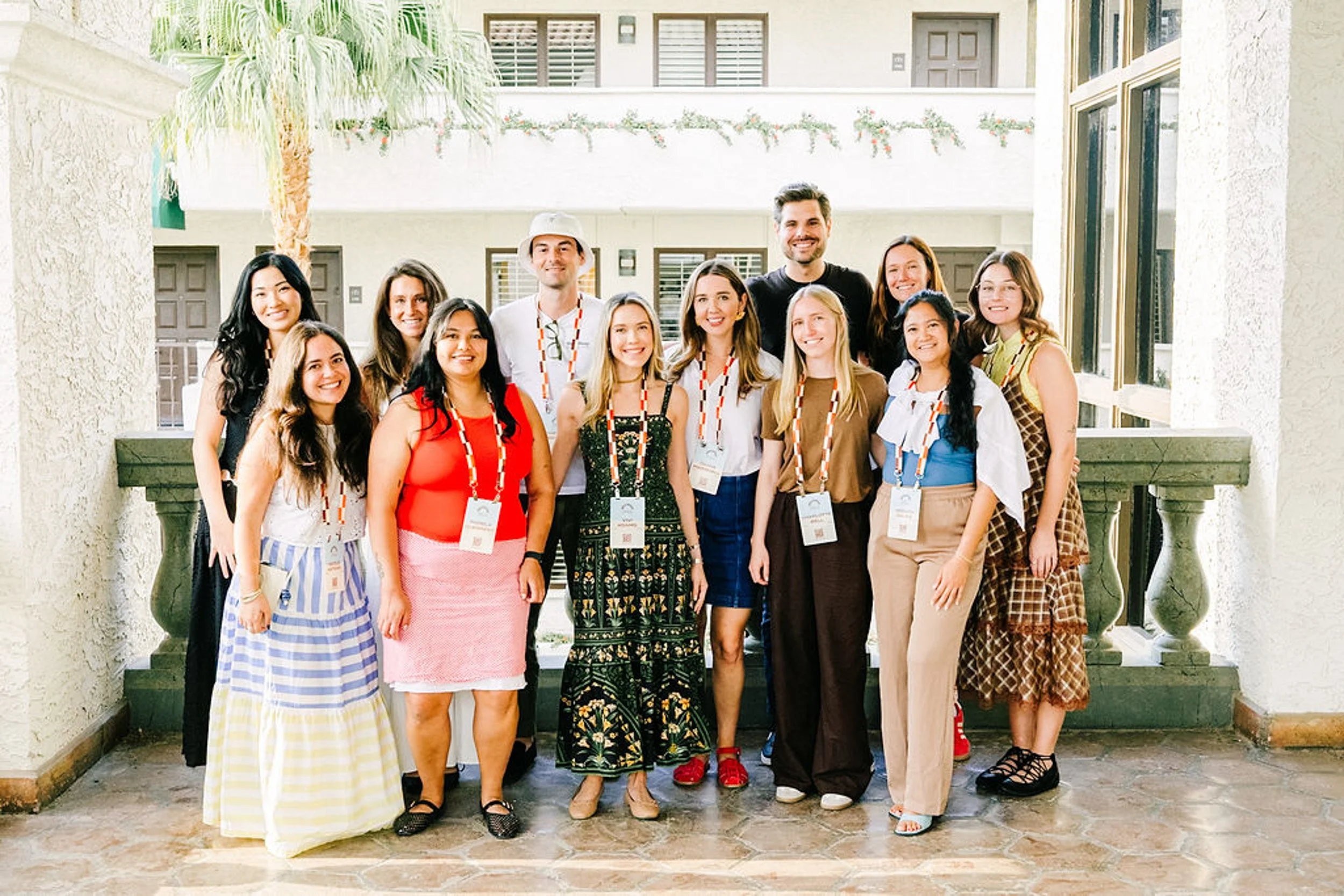 Corporate team with lanyards posing at a company offsite retreat photographed by Betsi Ewing