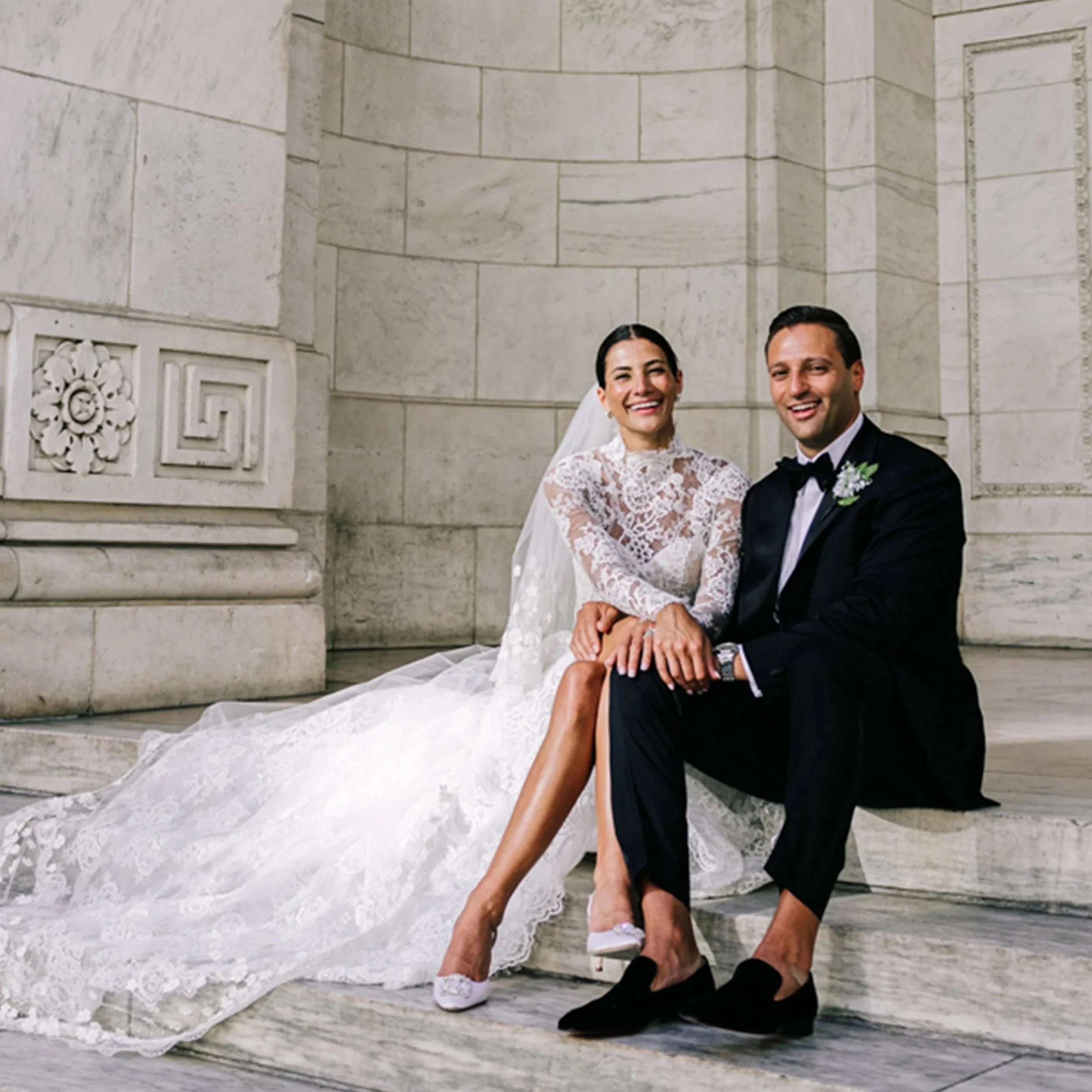 bride and groom on the steps of the New York Public Library on their wedding day captured by New York wedding videographer Betsi Ewing