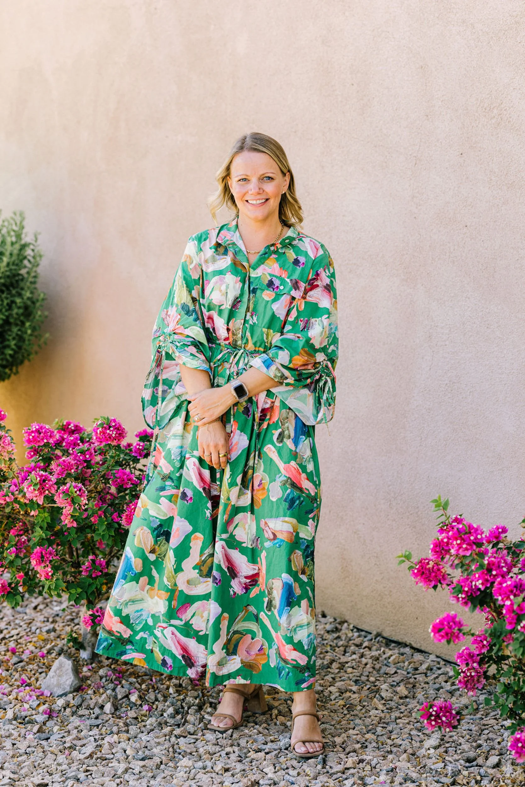 Professional branding portrait of a woman in a floral dress with bougainvillea in Denver