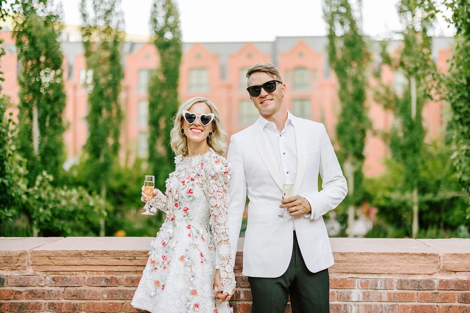 bride and groom smiling and wearing cute sunglasses on their wedding day at the st regis aspen resport in aspen, colorado