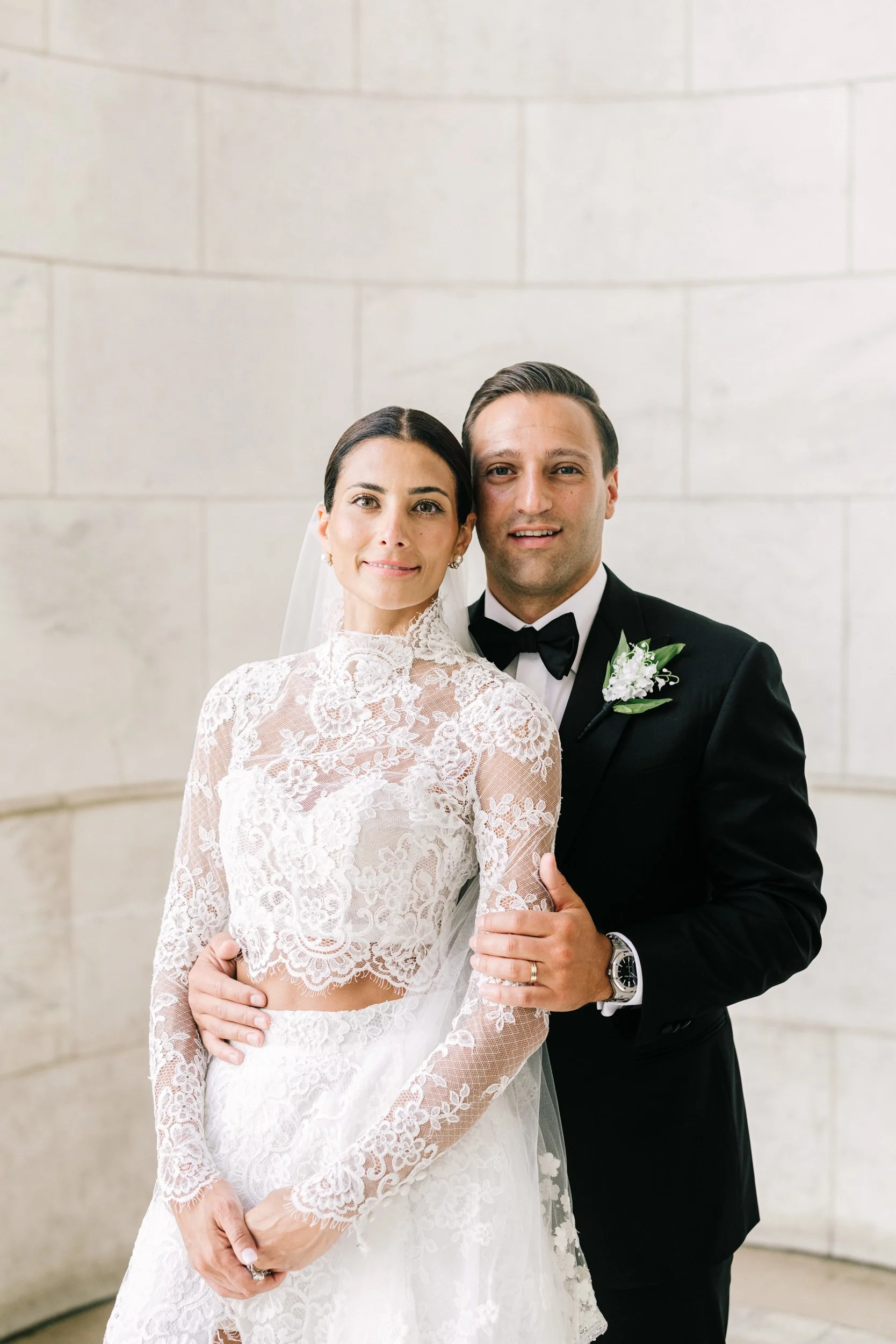 Bride and groom embracing in a romantic portrait at the New York Public Library, New York City wedding