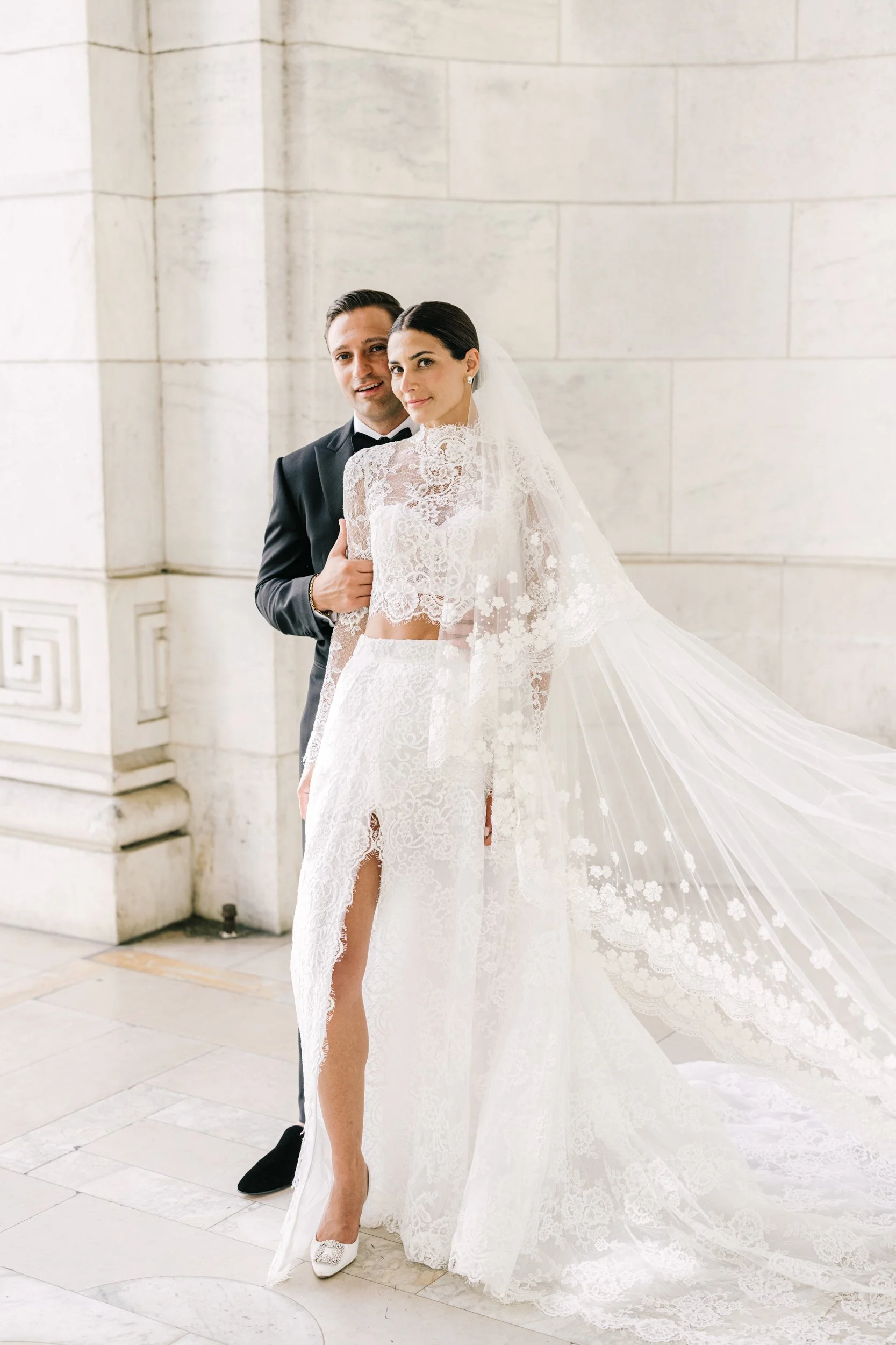 Bride and groom portrait with the bride's flowing veil at the New York Public Library, NYC wedding