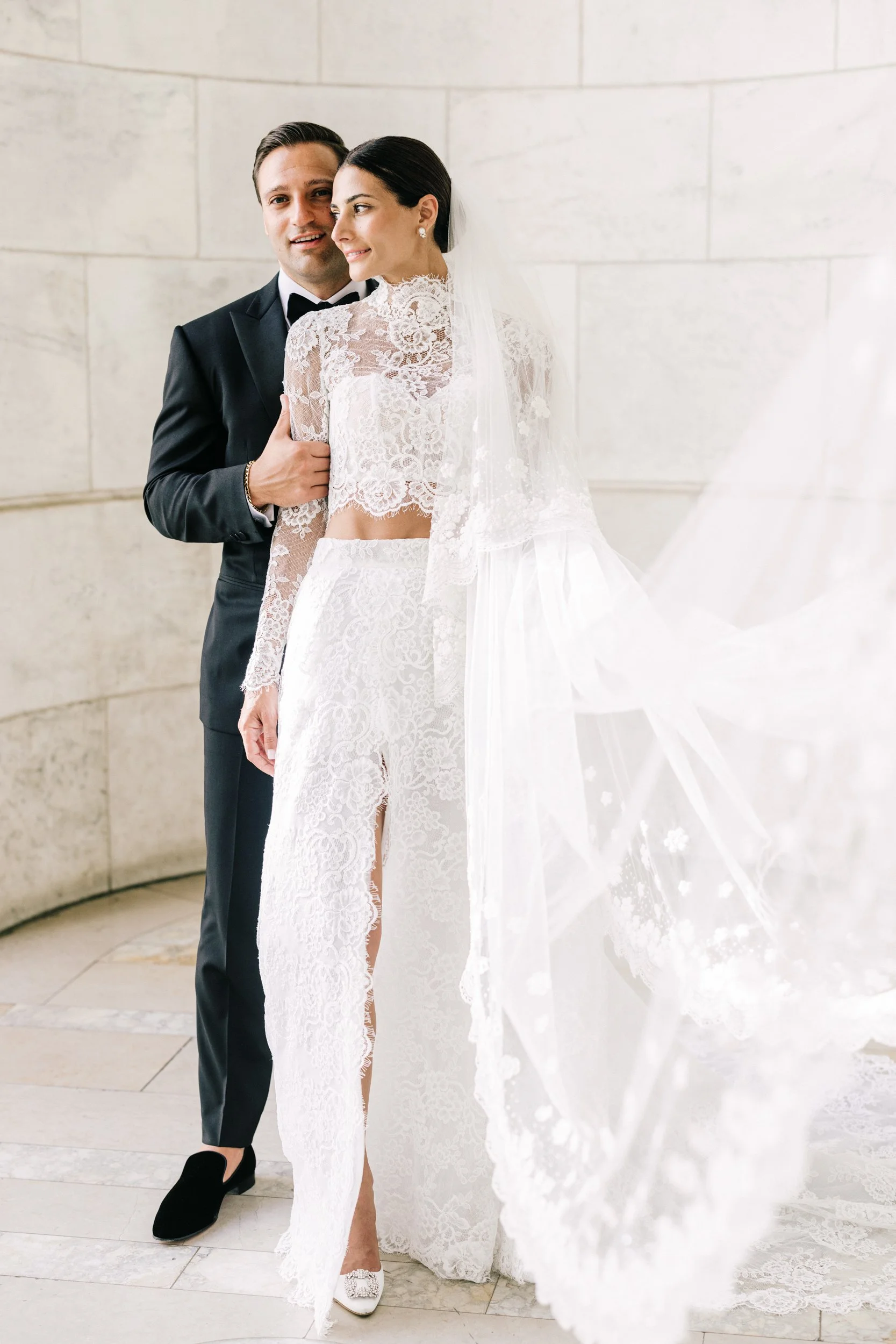 Bride and groom portrait with bride's veil cascading beautifully at the New York Public Library, NYC wedding