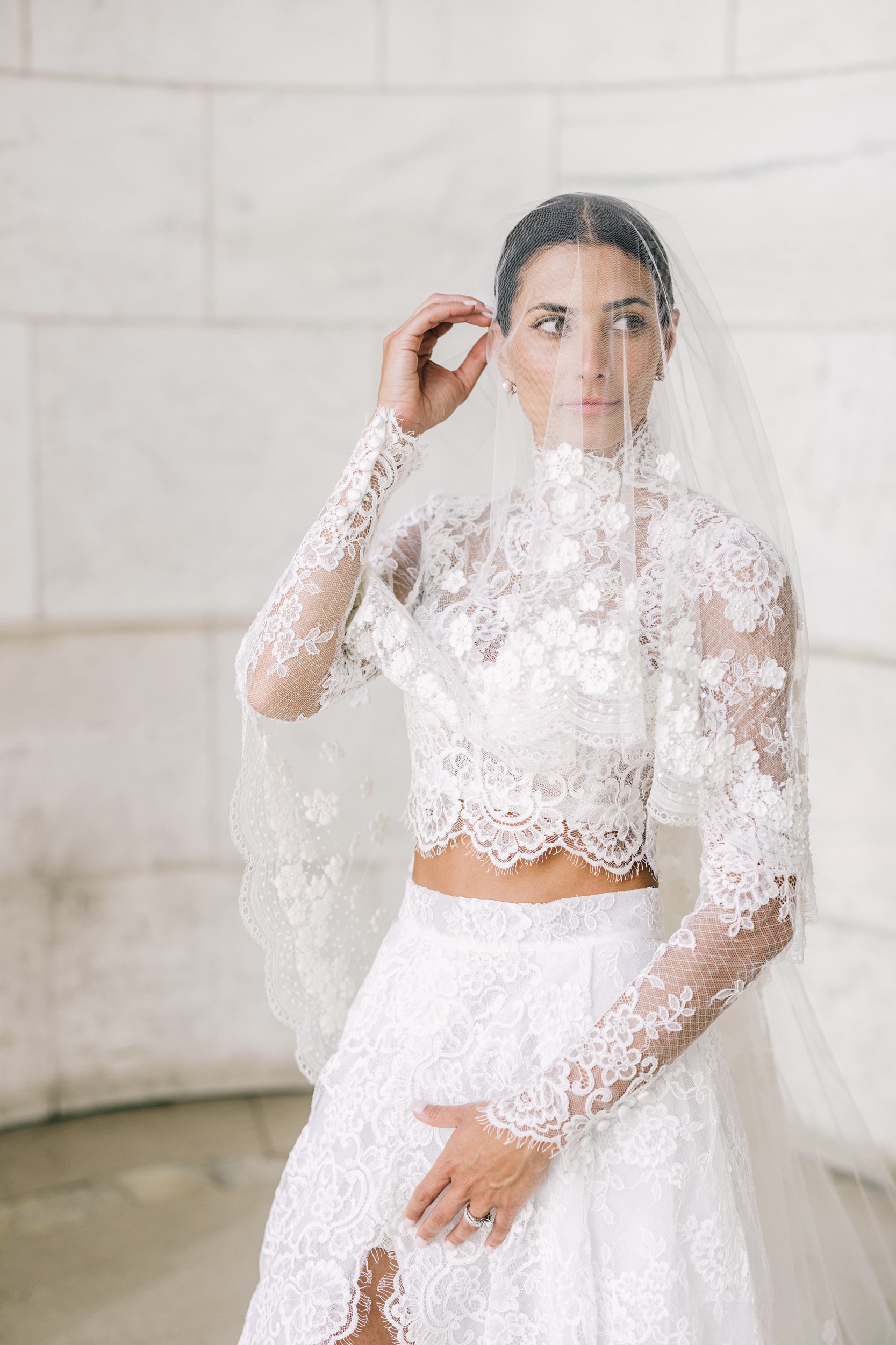 Bride lifting her veil in an elegant close-up bridal portrait at the New York Public Library, New York City wedding