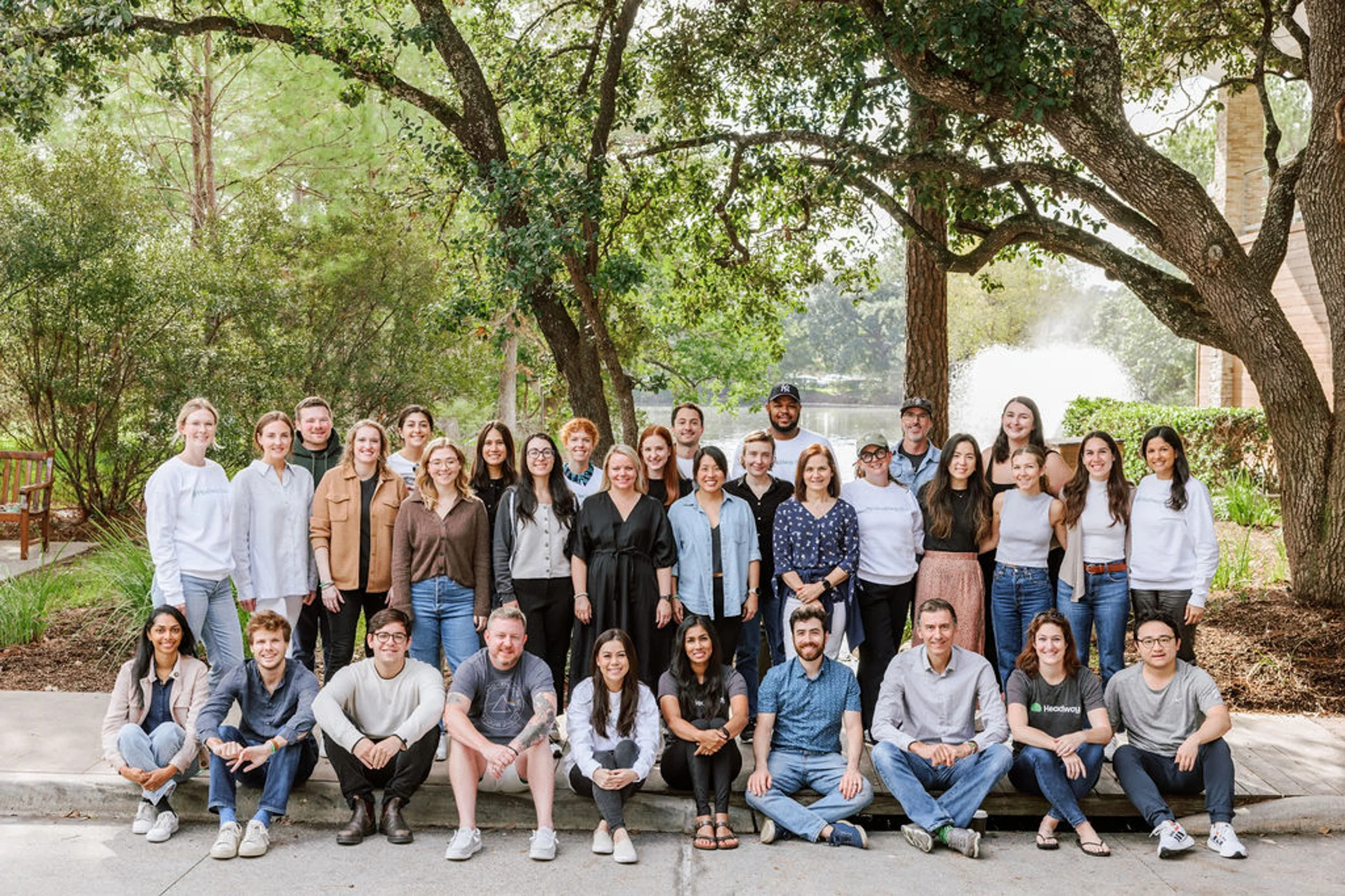 Team group photo seated on steps at a corporate retreat photographed by Betsi Ewing