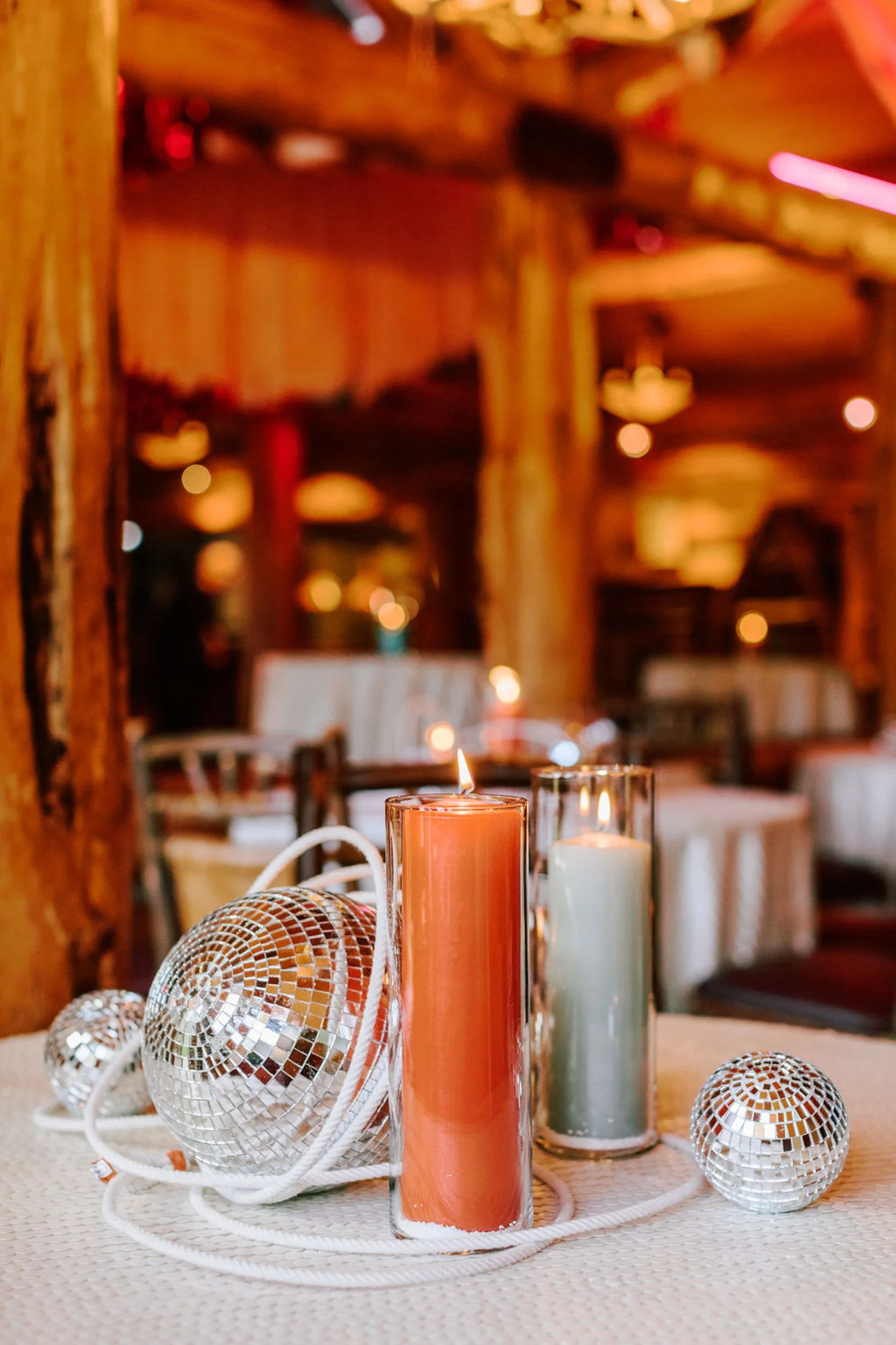 Candle and mini disco ball wedding table centerpiece detail at Pine Creek Cookhouse rodeo disco reception, Aspen Colorado wedding decor styling
