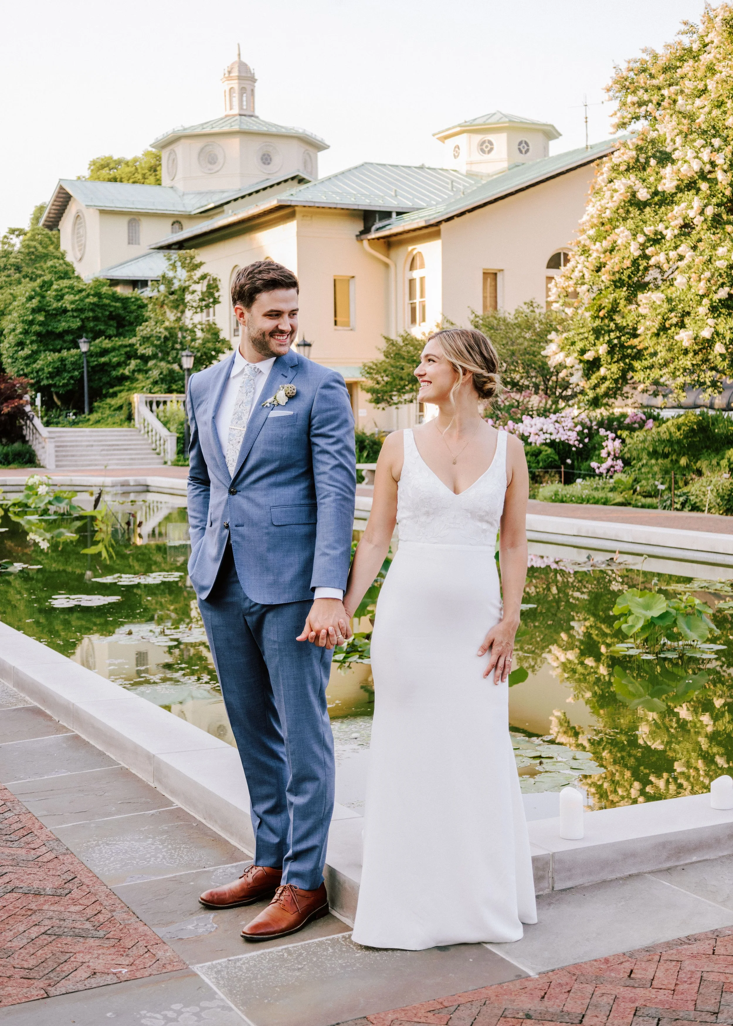 Bride and groom smiling in front of the pond during their Brooklyn Botanic Garden wedding