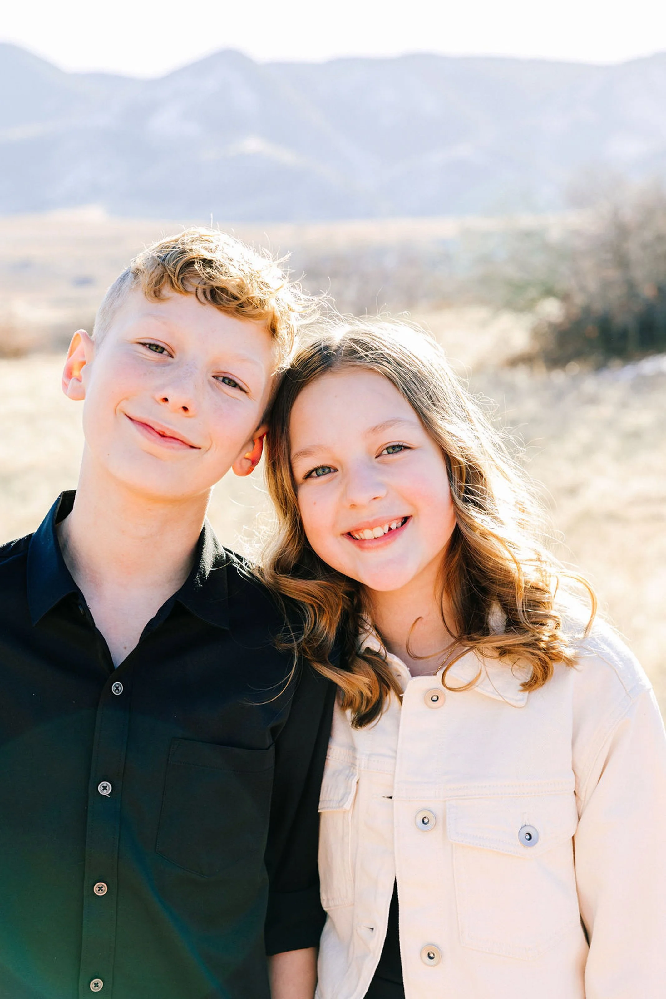 Siblings running together during outdoor family session in Denver