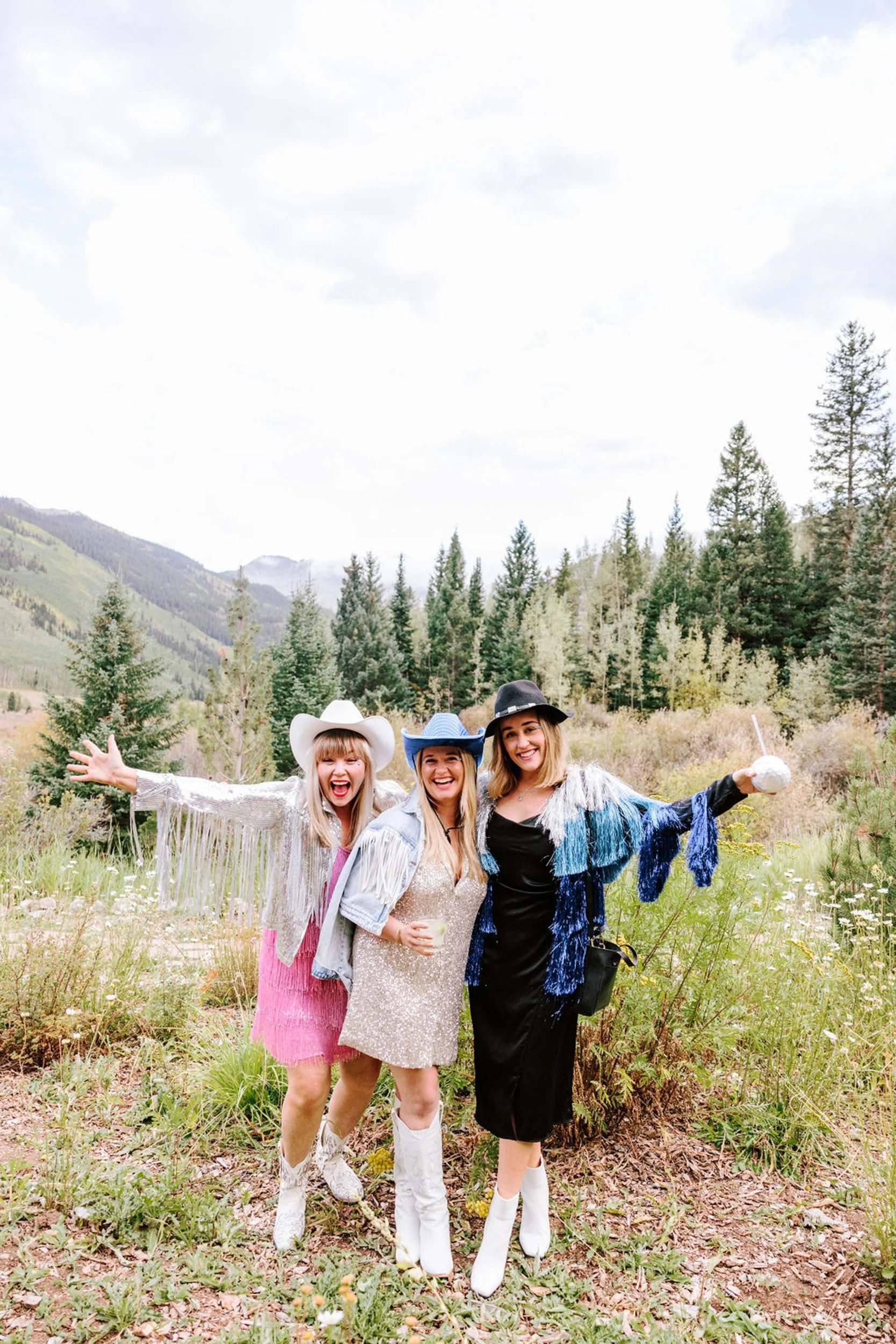Wedding guests with children posing in an Aspen mountain meadow at Pine Creek Cookhouse wedding in Colorado