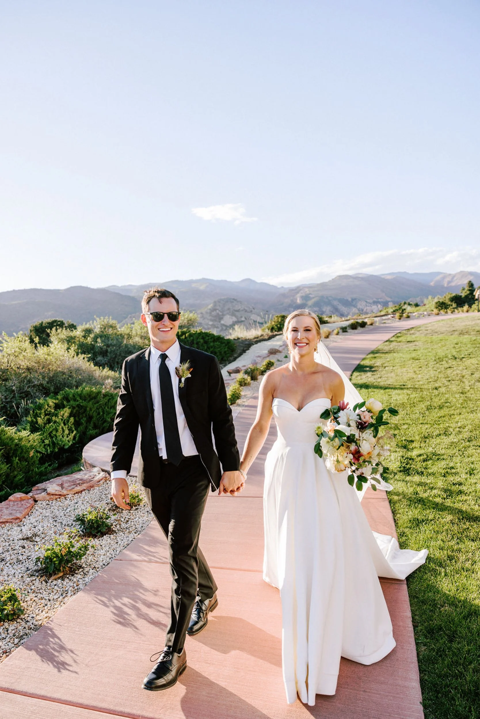Bride and groom walking through Garden of the Gods during their Colorado wedding photographed by Betsi Ewing