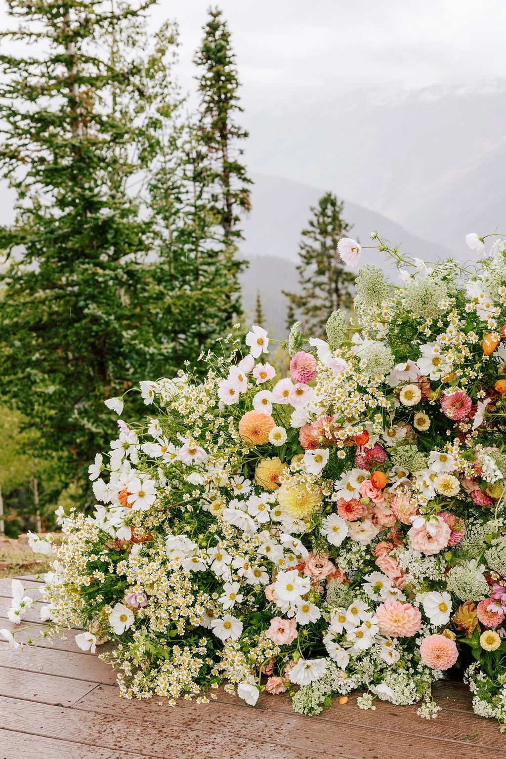 a beautiful view of the mountains on top of aspen mountain at the little nell during a colorado elopement