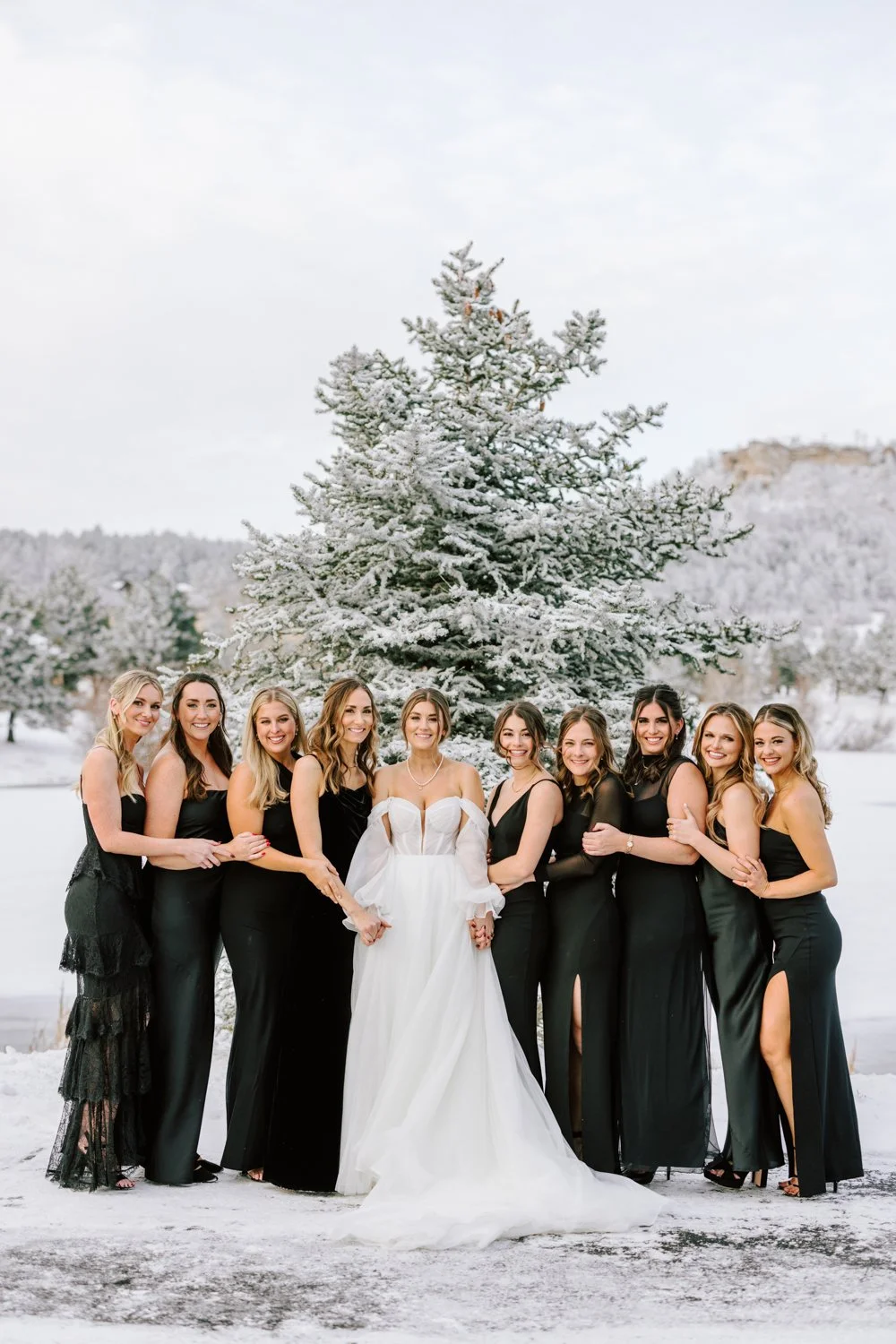 Bride and bridesmaids celebrating a winter wedding at Spruce Mountain Ranch in Larkspur, Colorado