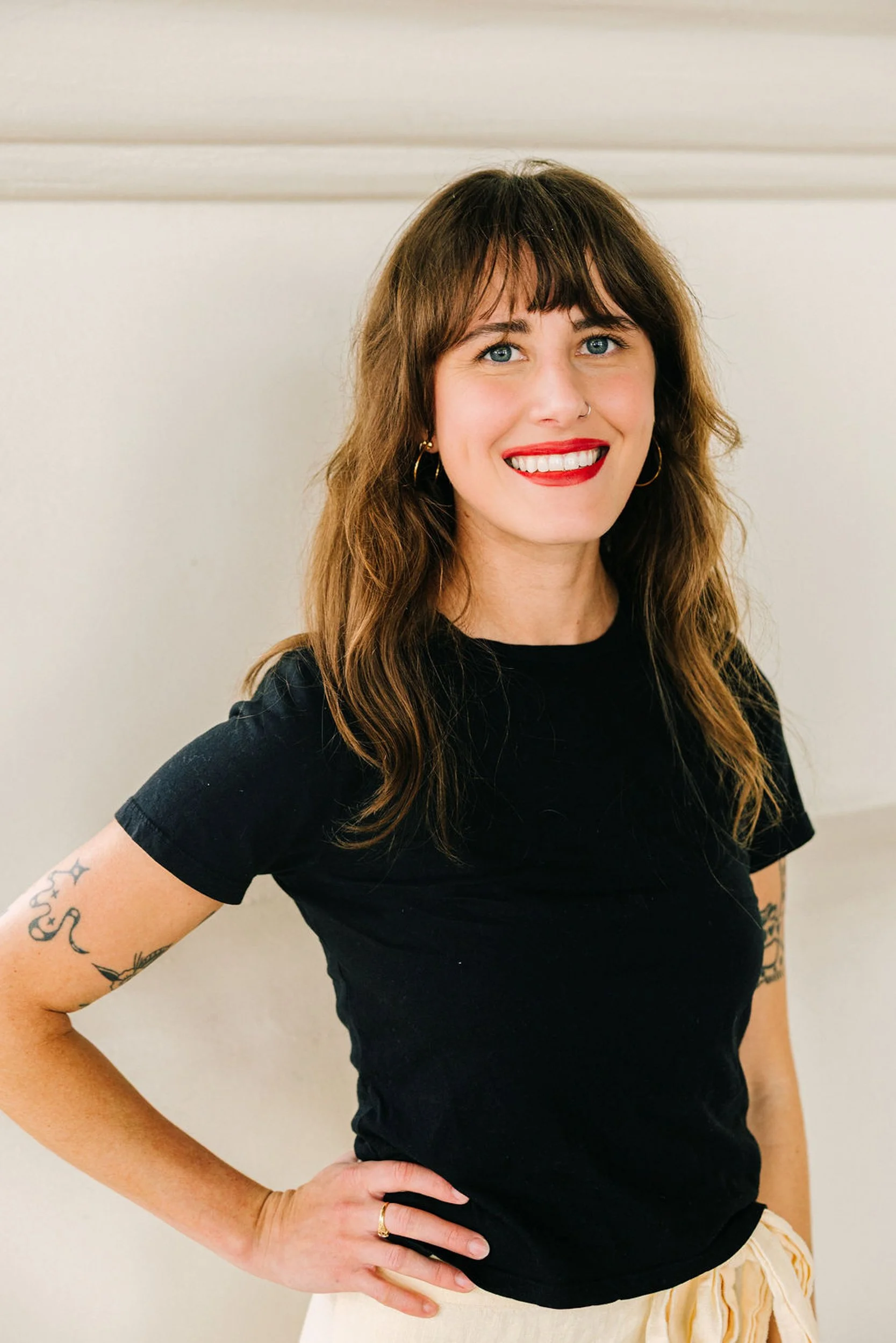 Business headshot of a woman in a black top with natural light in Denver, CO
