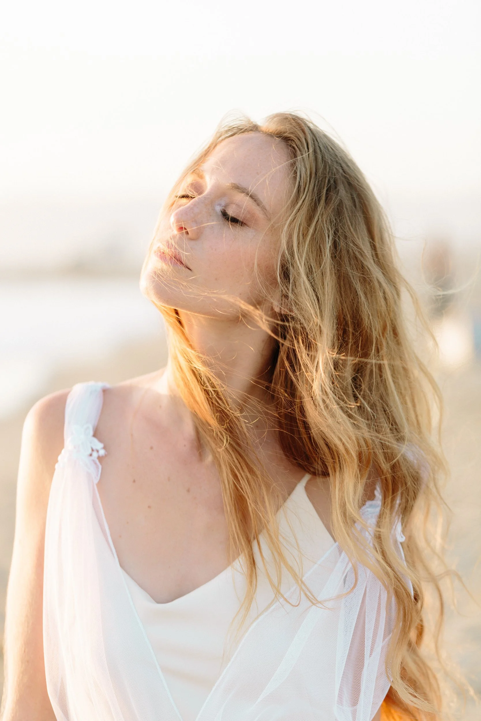 Golden hour actor headshot of a woman in profile on the beach by Denver headshot photographer Betsi Ewing