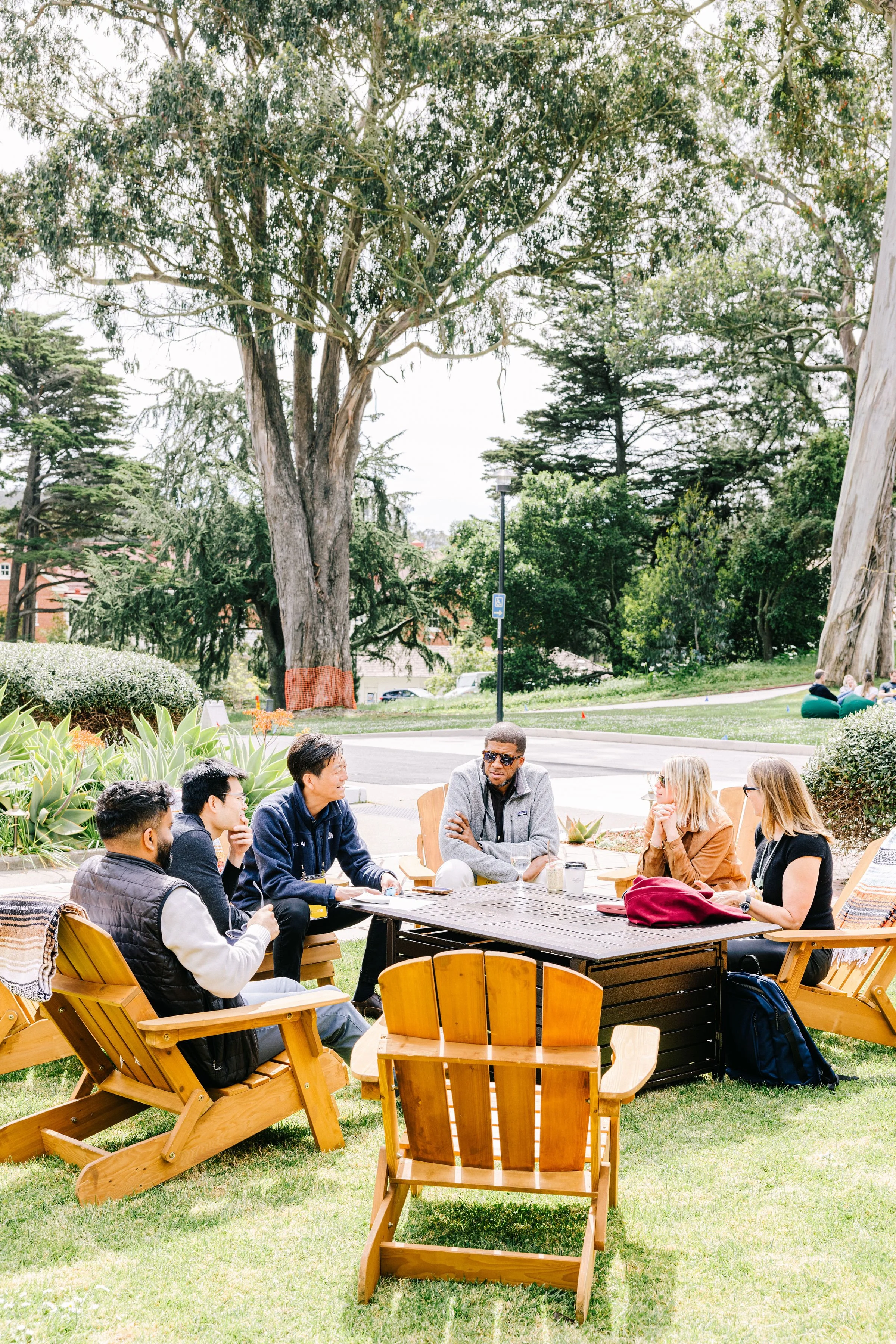 Small group meeting outdoors at a corporate offsite event photographed by Betsi Ewing
