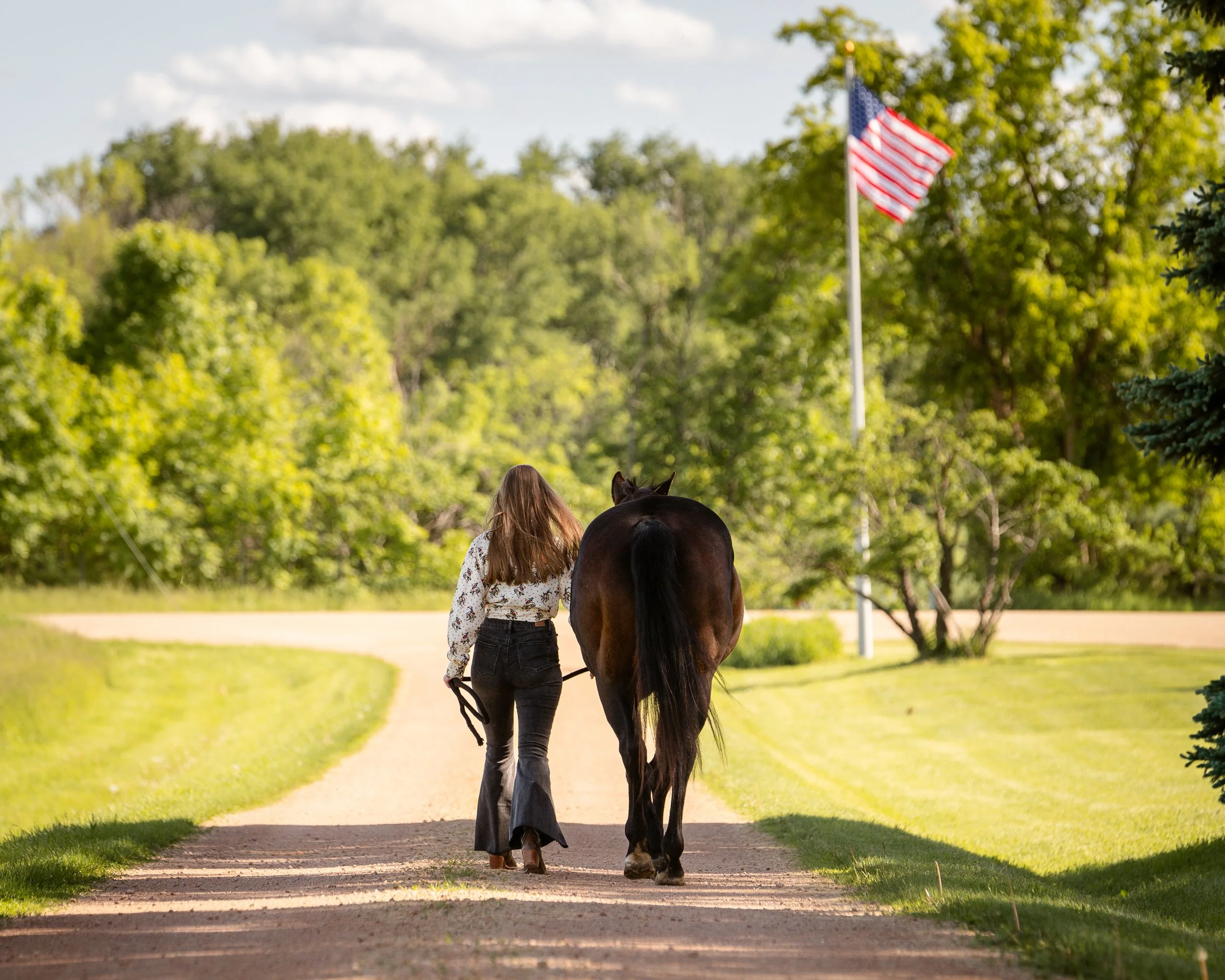 senior girl with horse walking American flag