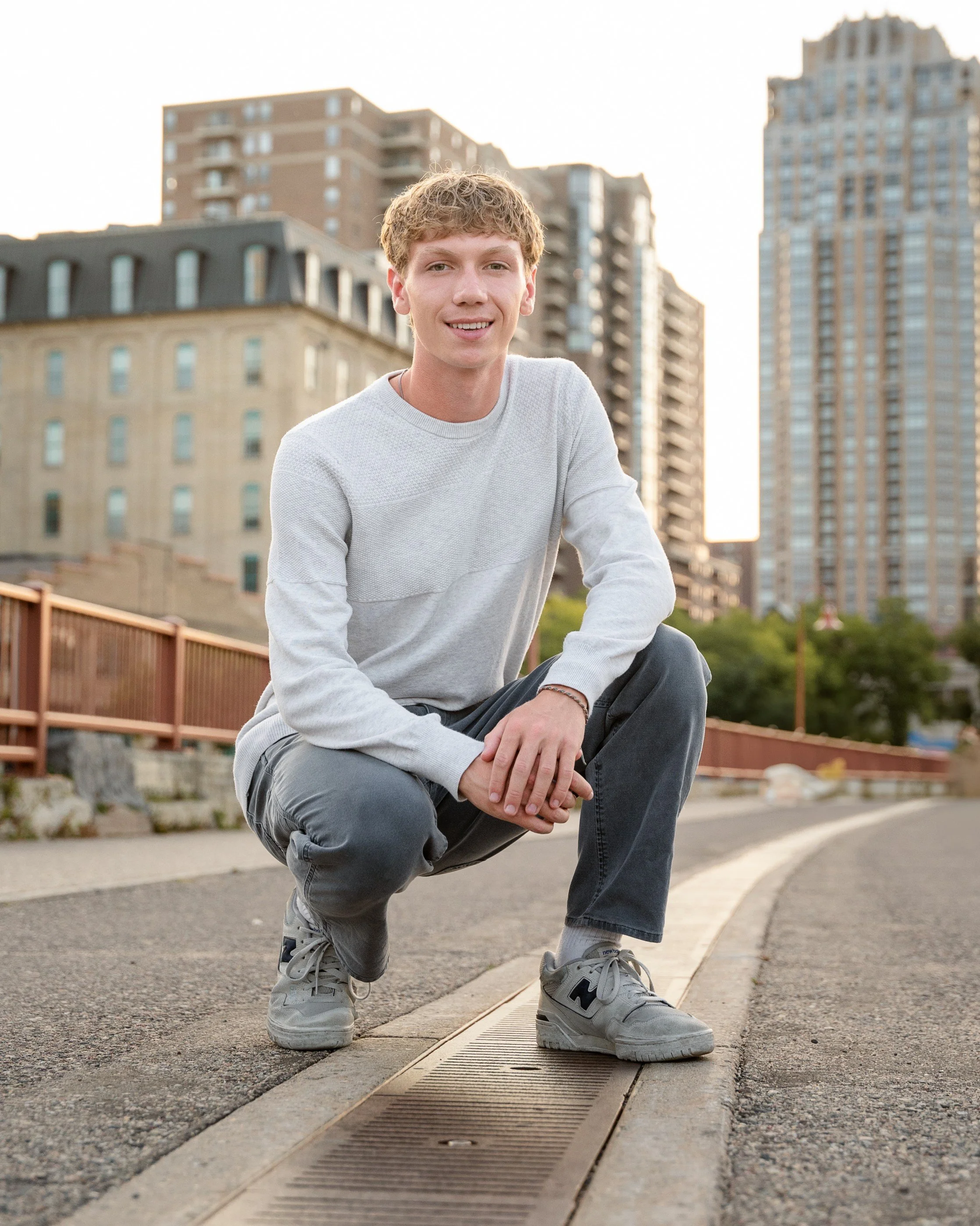 senior boy saint anthony main bridge minneapolis skyline