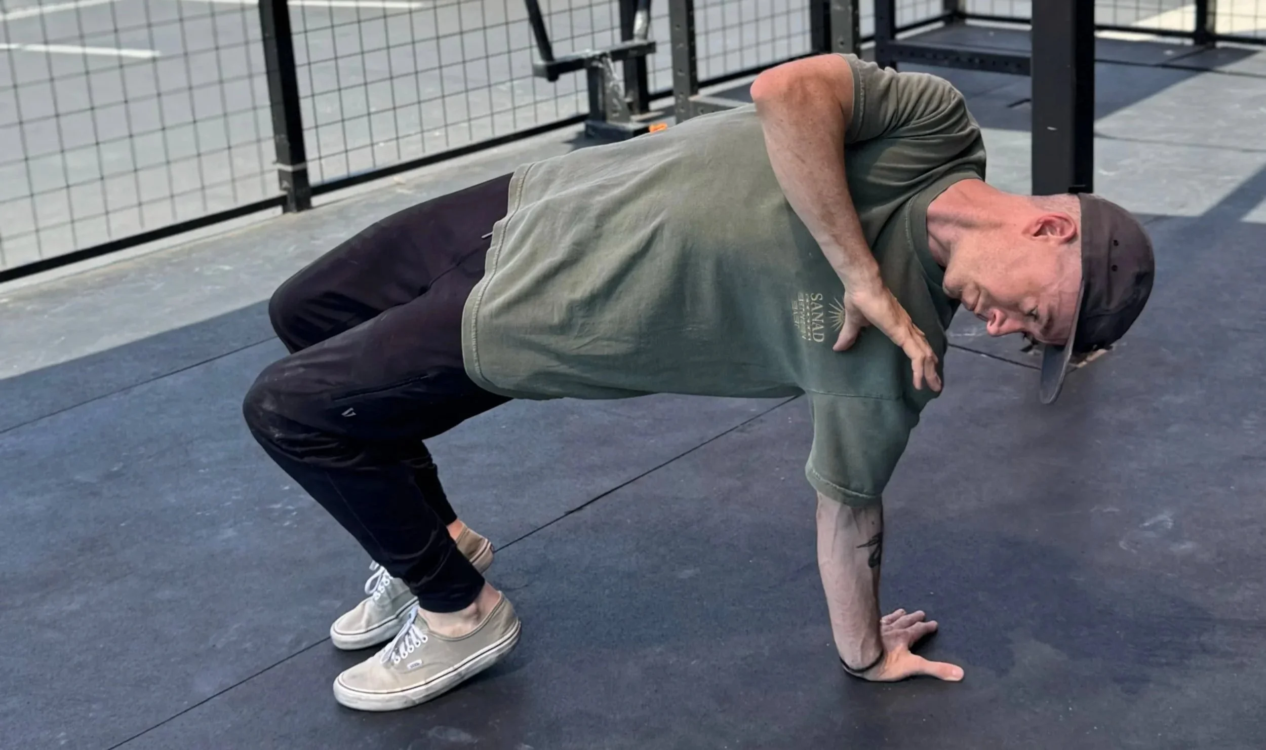 man doing one arm bridge