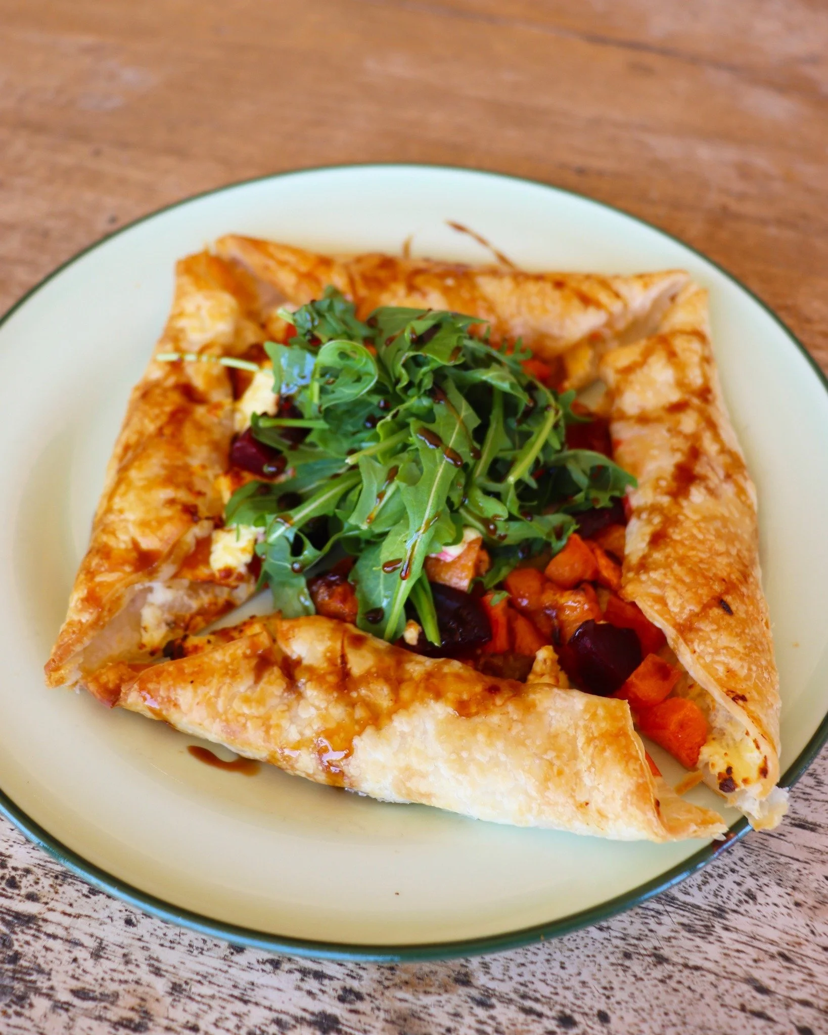 ✨ Crispy, golden &amp; bursting with flavour! ✨

Our Vegetable Galette (V) is layered with roasted sweet potato, butternut pumpkin, caramelised onion, beetroot, creamy ricotta &amp; local feta, all drizzled with a pomegranate molasses swirl and toppe