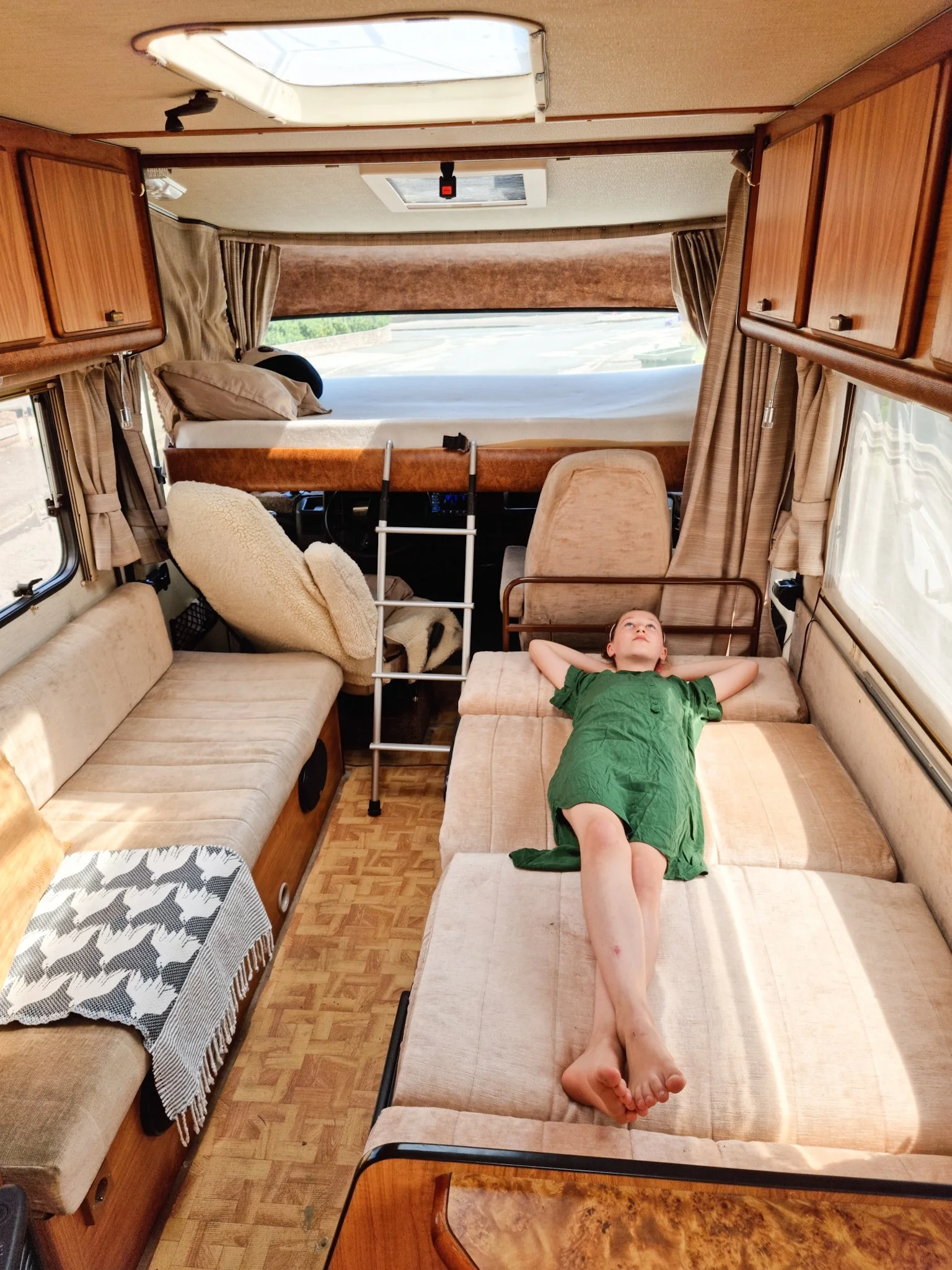 Alice's daughter Nancy, lying stretched out on the bed in the campervan.