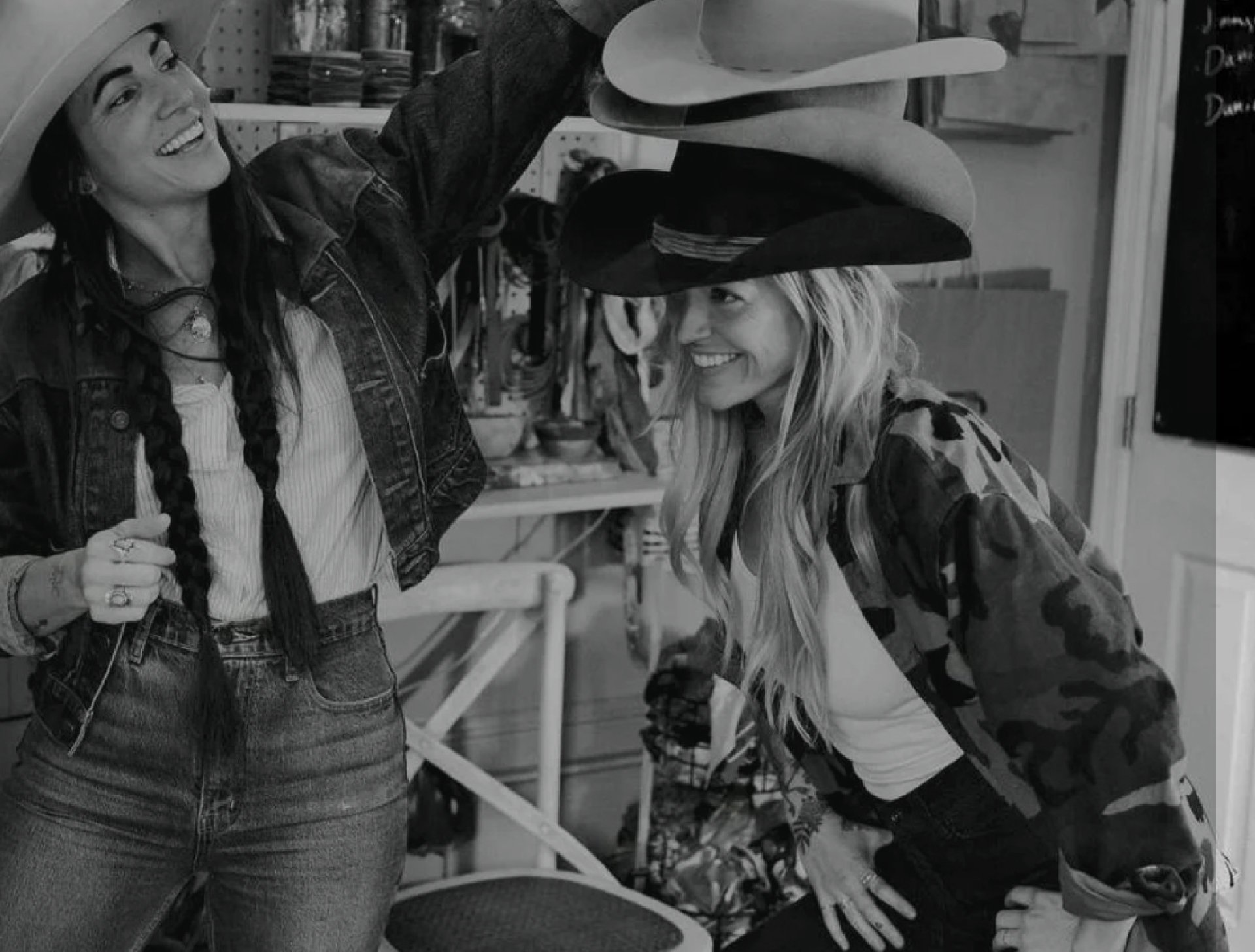 The owners of Nic & Maude trying on hats