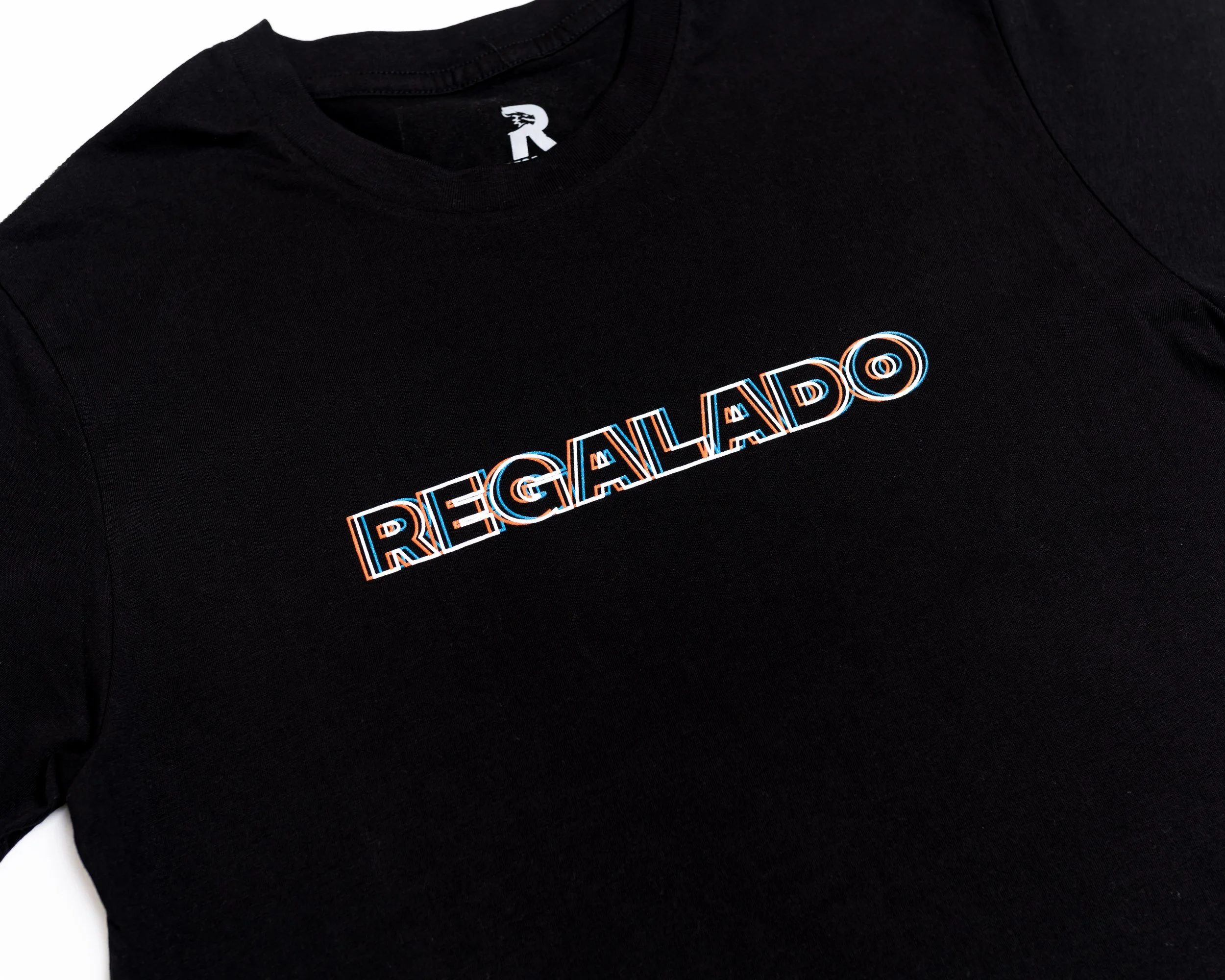 Black T-shirt with the word "REGALADO" in colorful, outlined text across the chest.