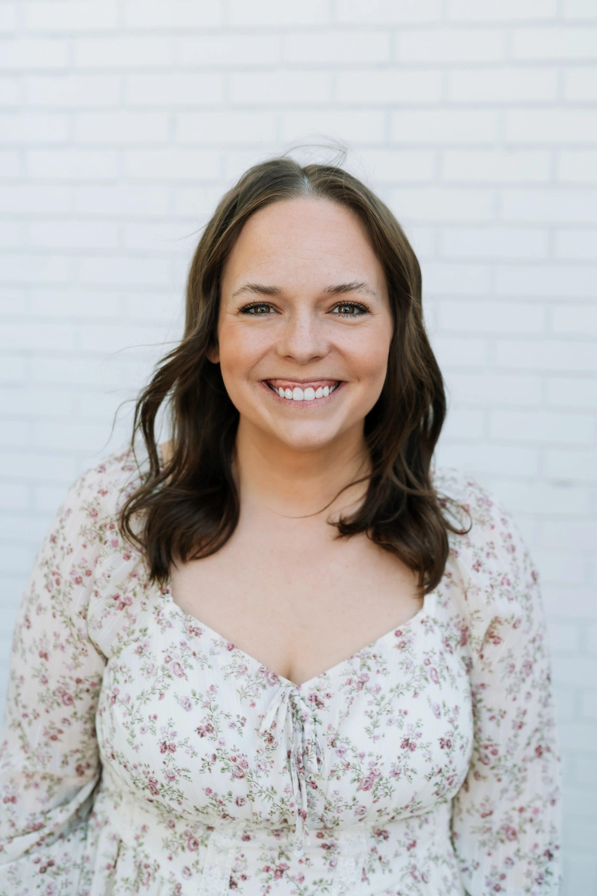 Amber is a woman with brown hair in a black top