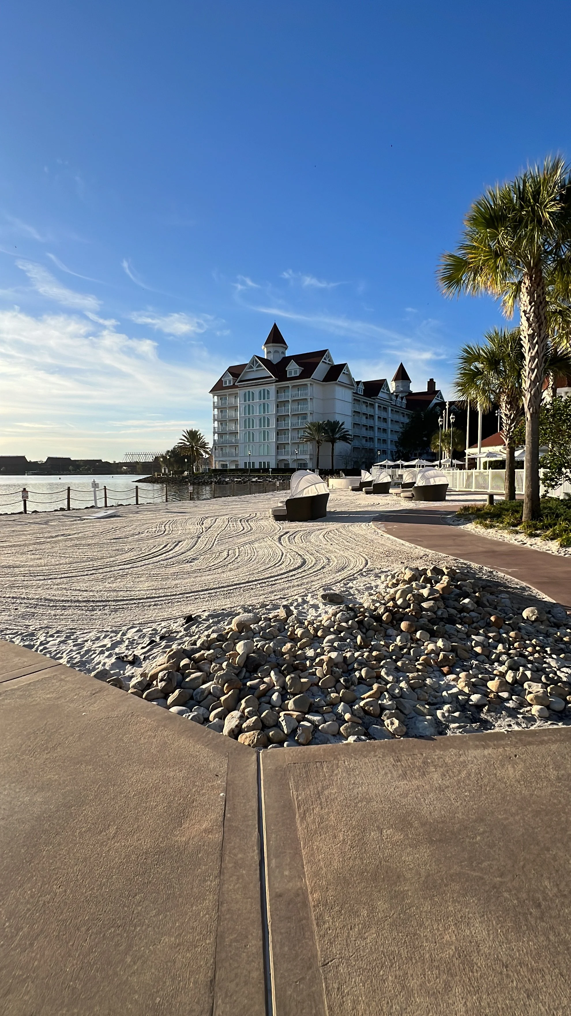 a white hotel with patches of sand