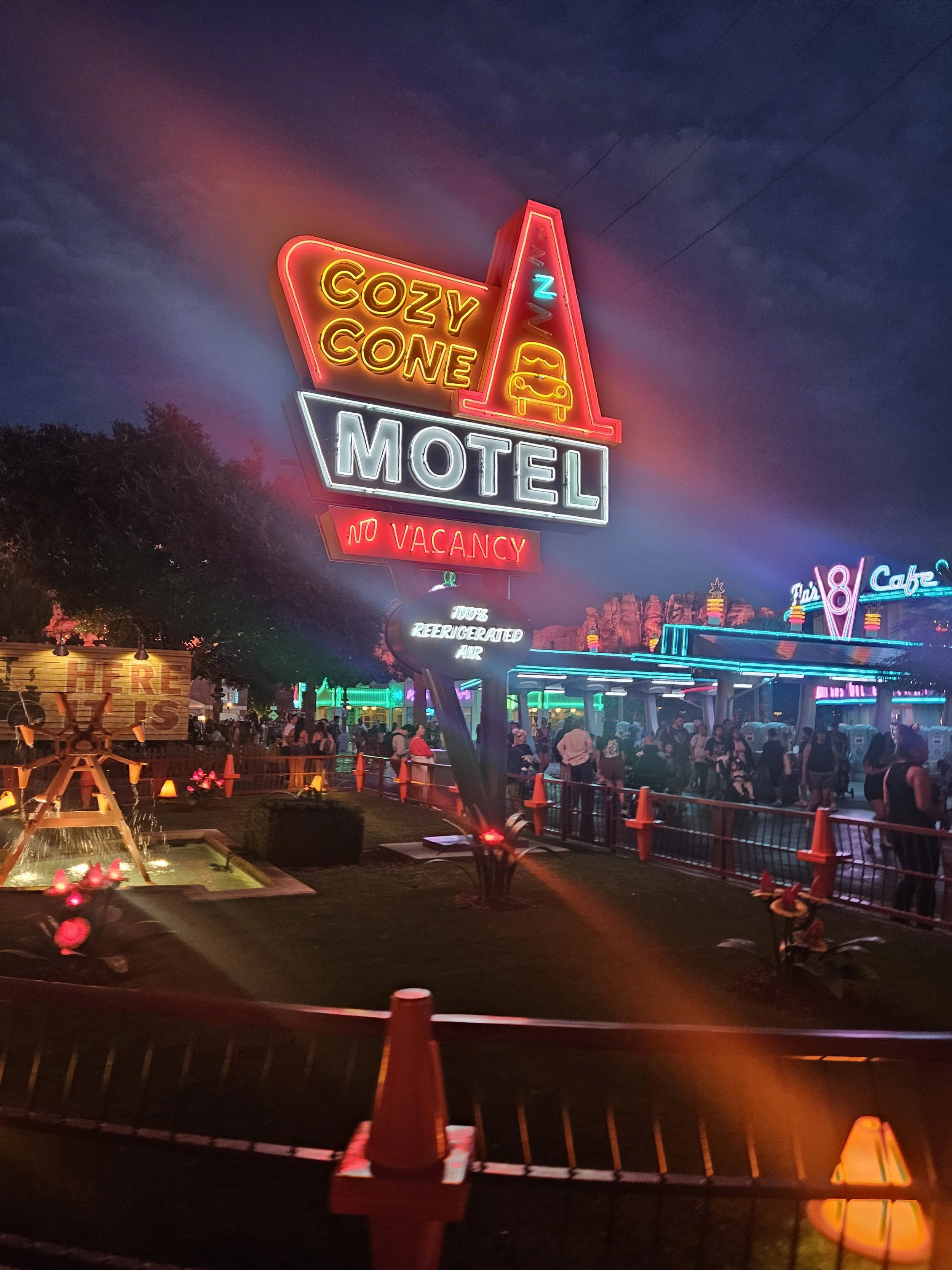 a neon sign at night that reads cozy cone motel