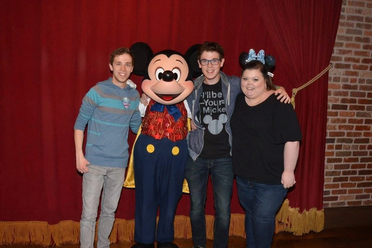 Aaron Guest with Mickey Mouse and friends backstage at Walt Disney World.