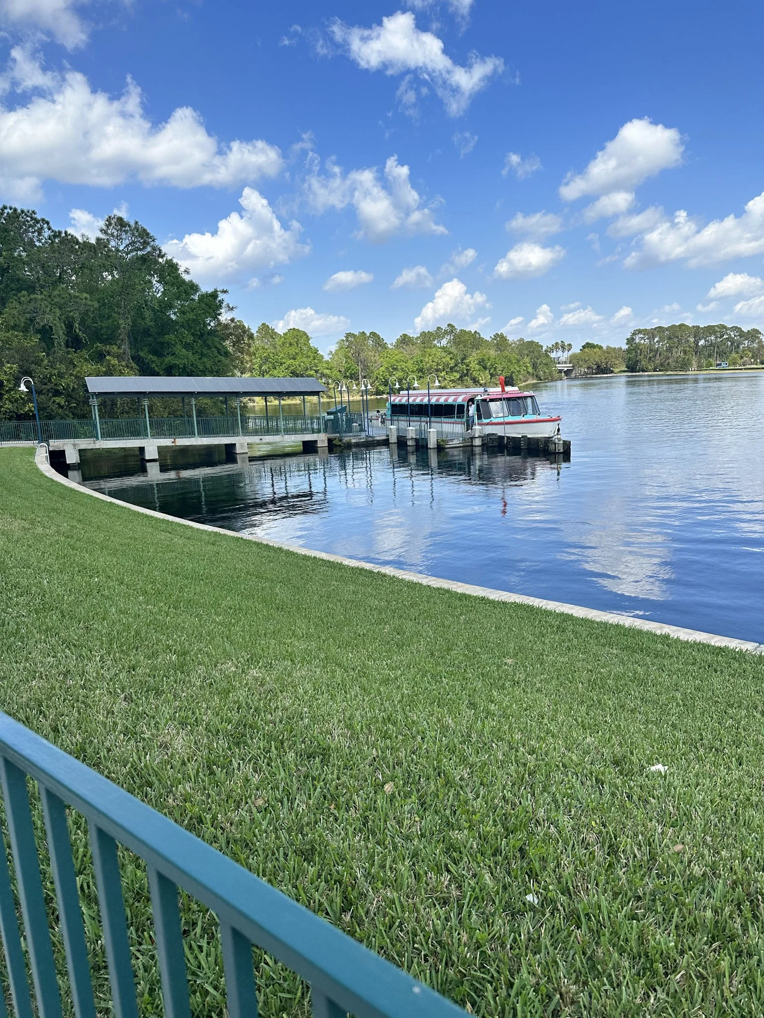 a red and blue boat on a lake