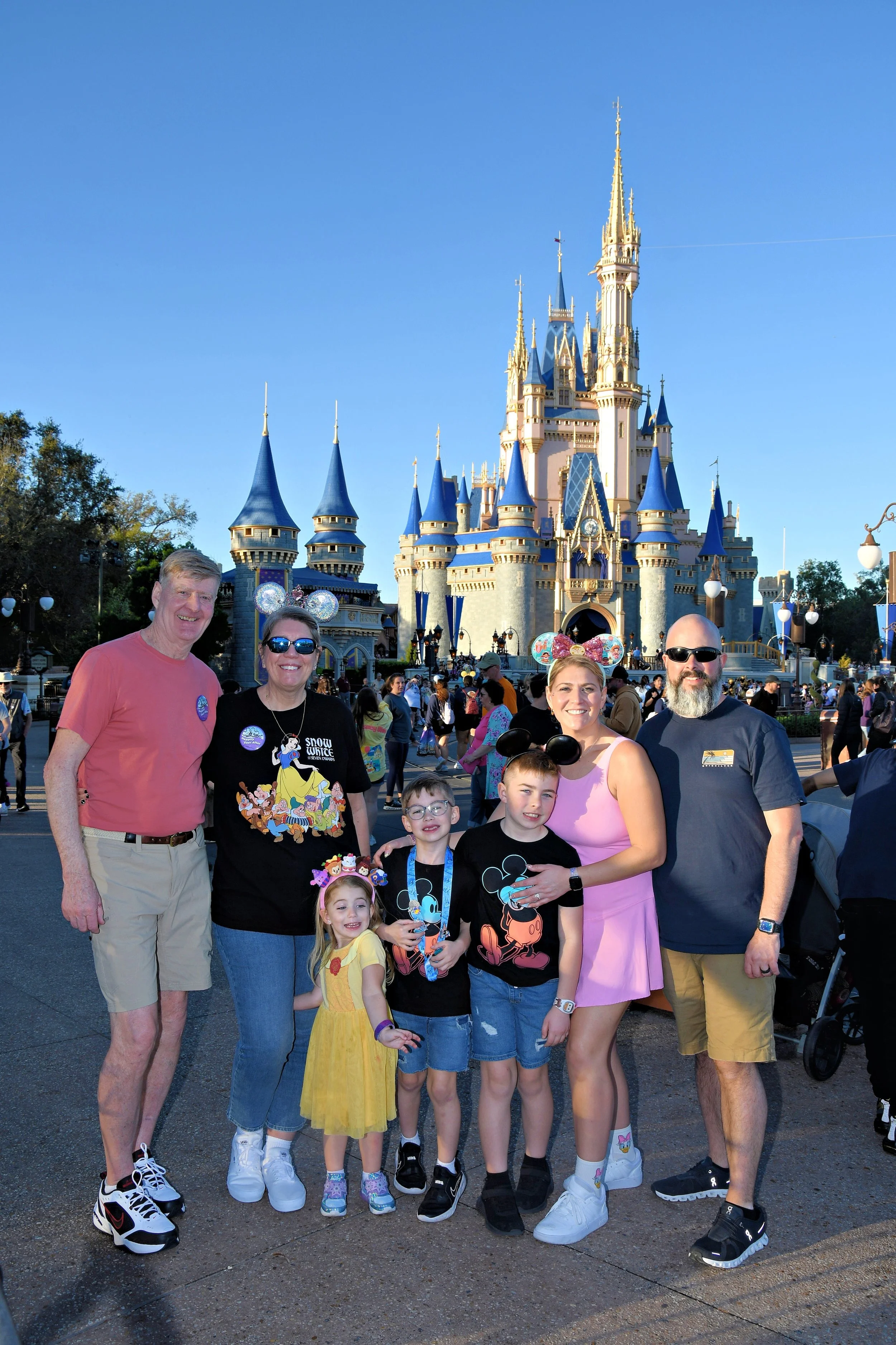 travel advisor lauren with her family in front of cinderella castle in magic kingdom