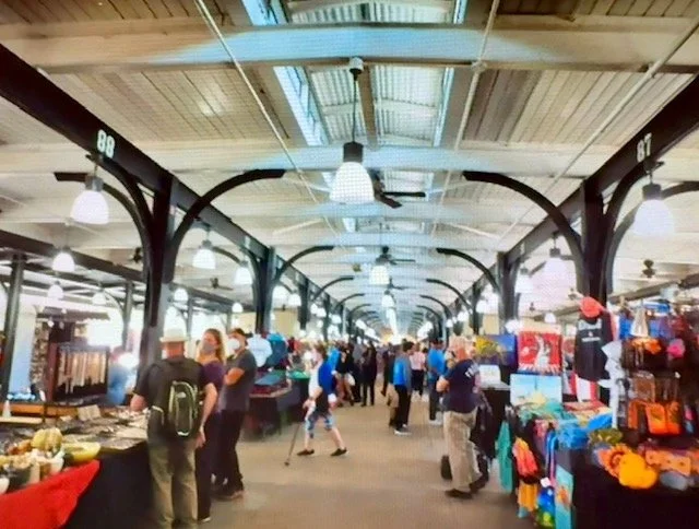 Shoppers browse vendor stalls inside the historic, covered French Market in the French Quarter.