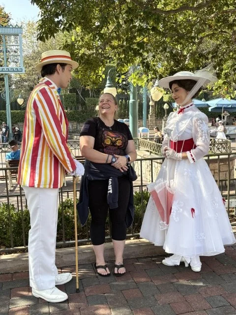 Aly laughing with Mary Poppins and Bert at Disneyland.