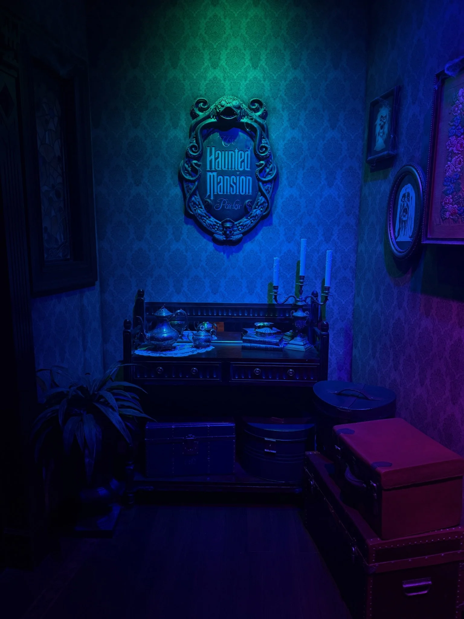 a purple and green lit room with a haunted mansion sign