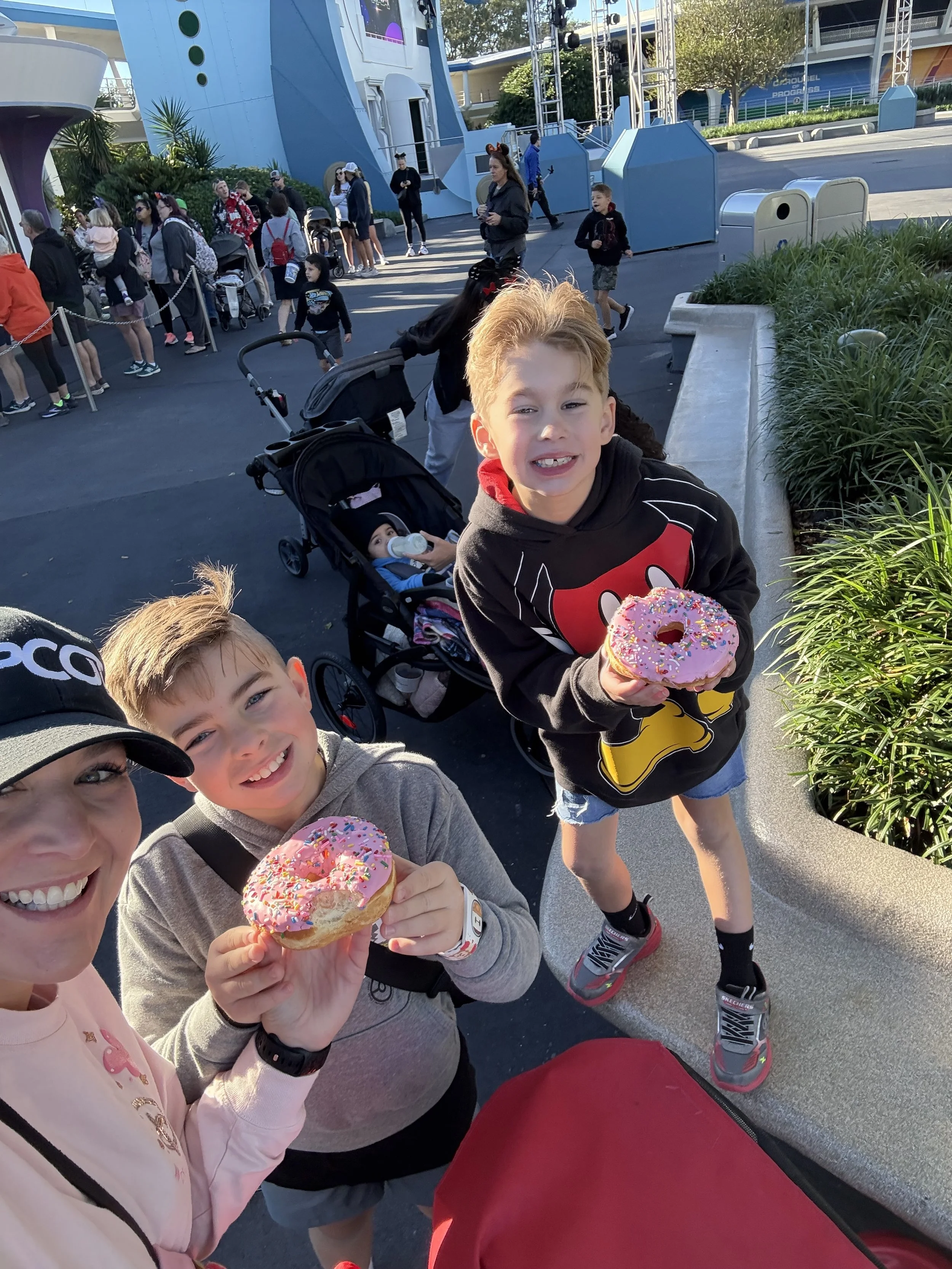a mom and her two kids eating donuts