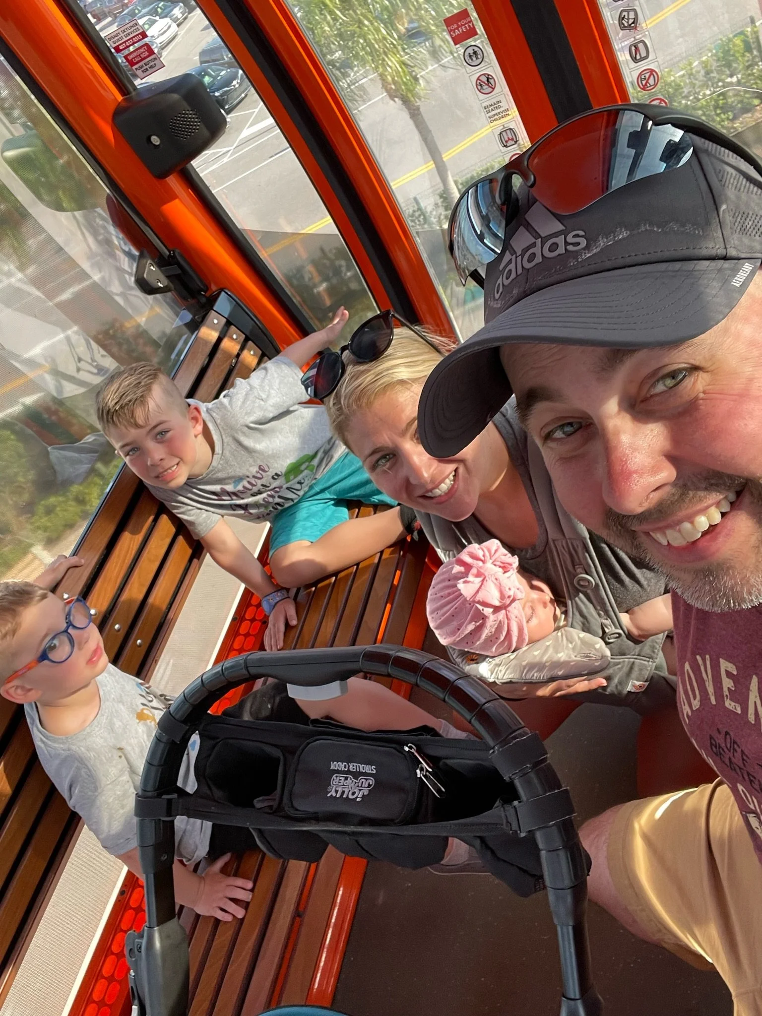 a family of 5 posing for a picture while on the skyline at disneyworld