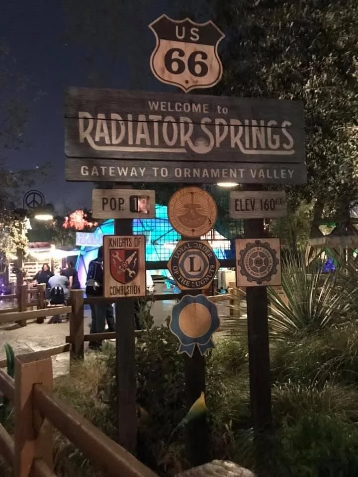 multiple signs on one pole that says radiator springs