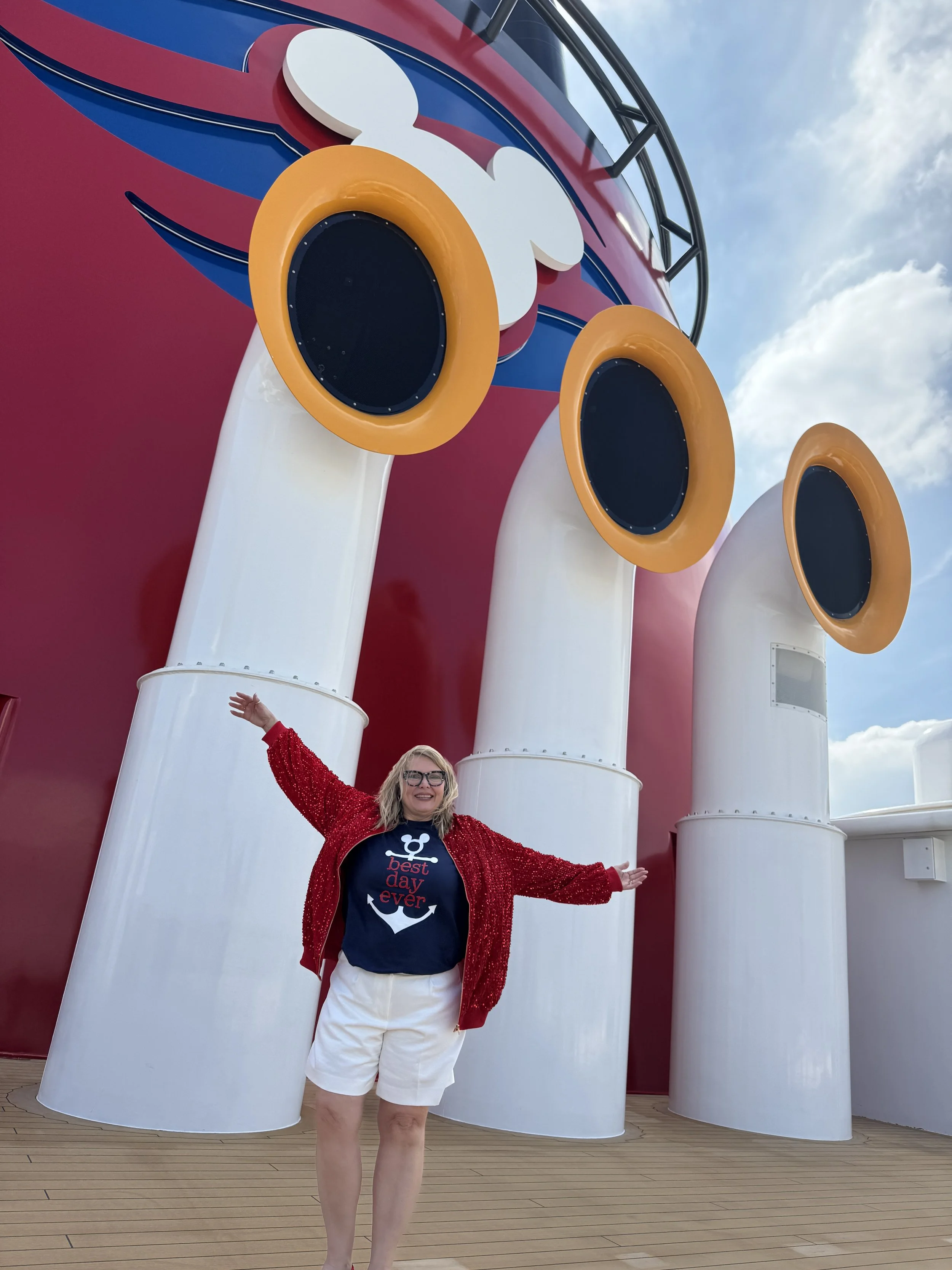 woman (amy blades standing in front of the disney cruise line funnel
