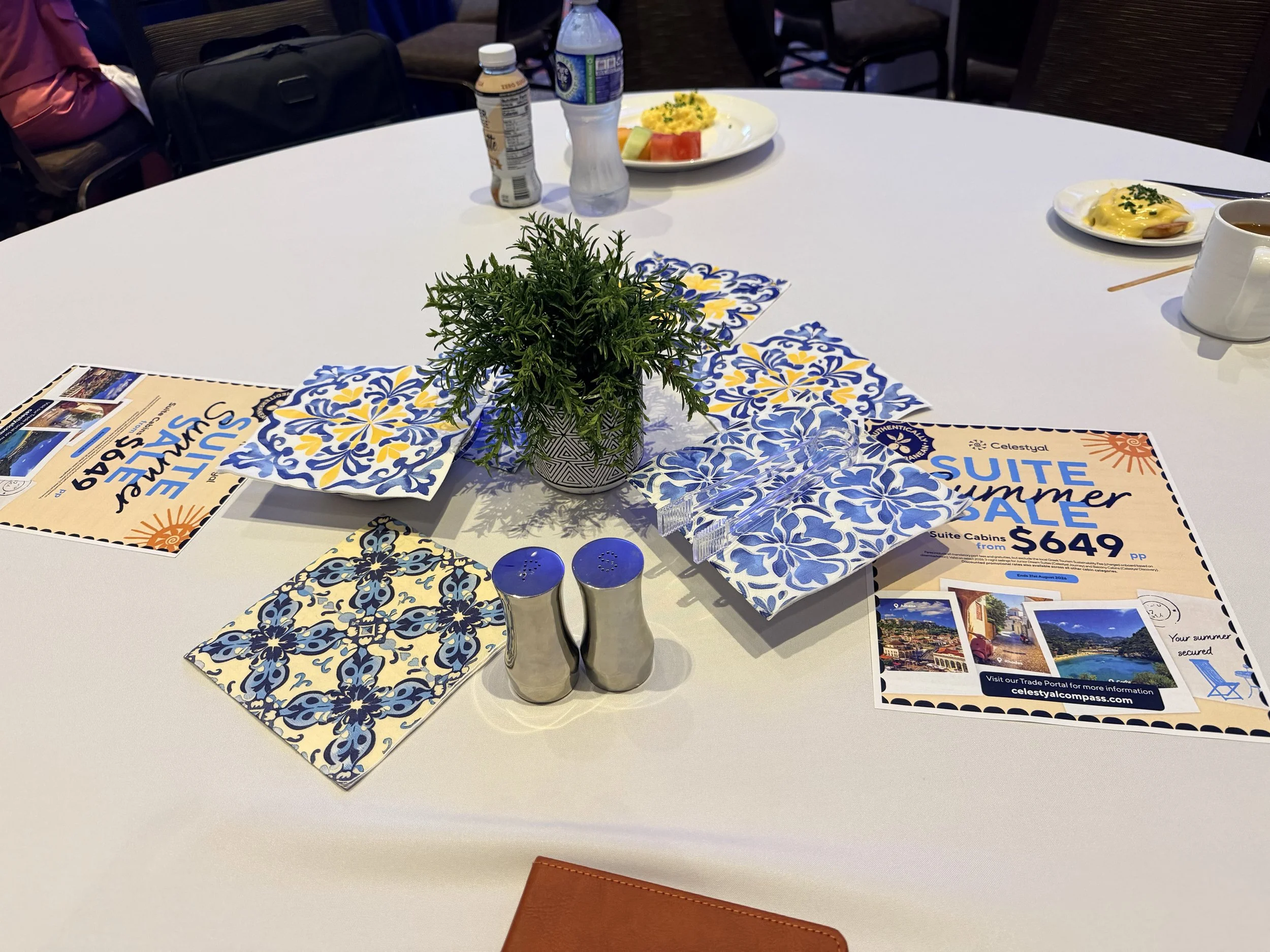 a round table with a plant and napkins