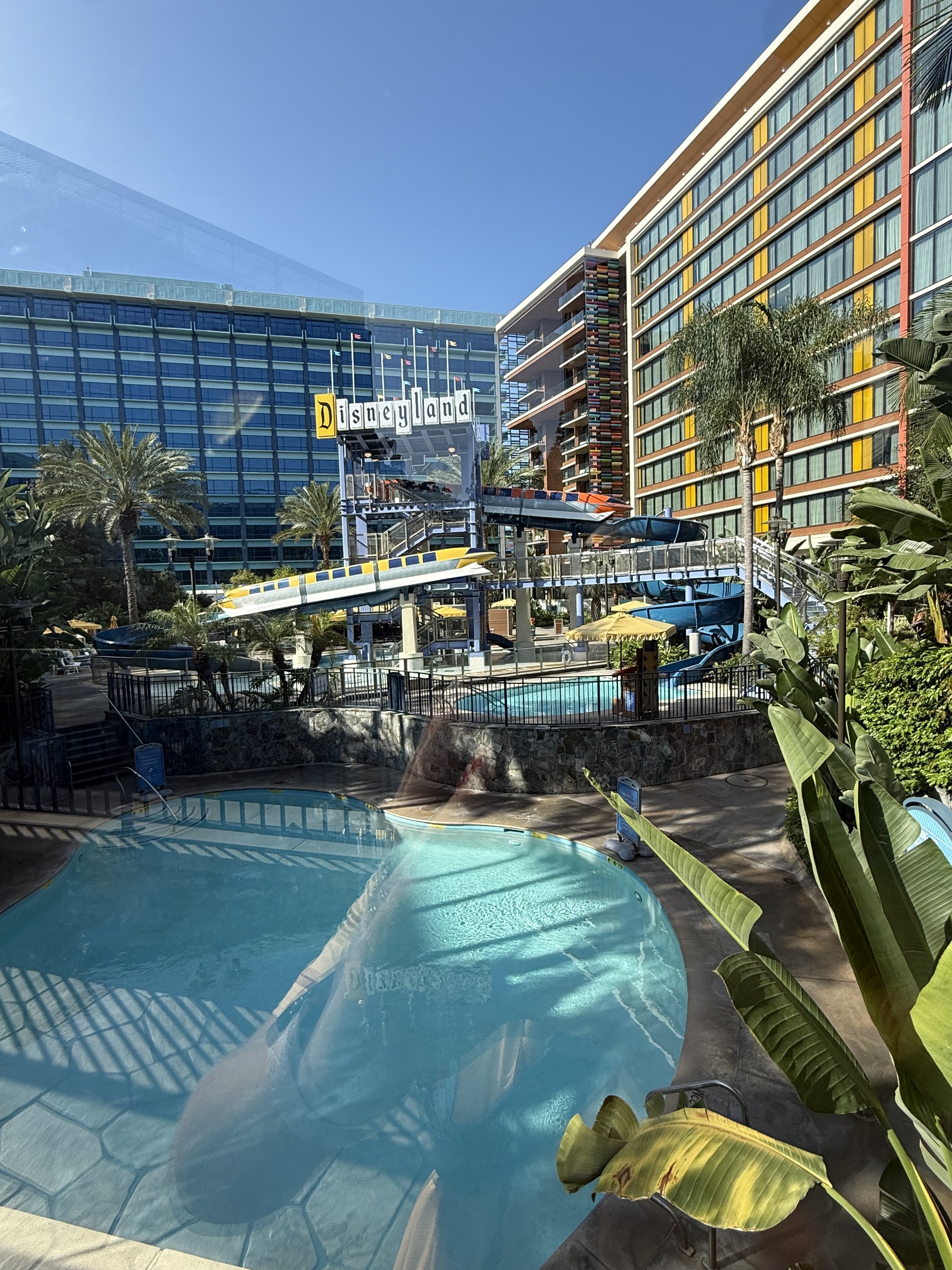 a hotel with a pool and a disneyland sign