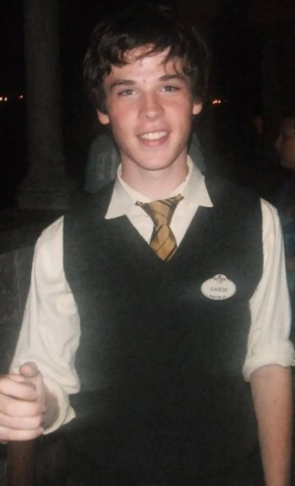 Aaron Guest in his Disney Cast Member vest and name tag during an evening shift at Walt Disney World.