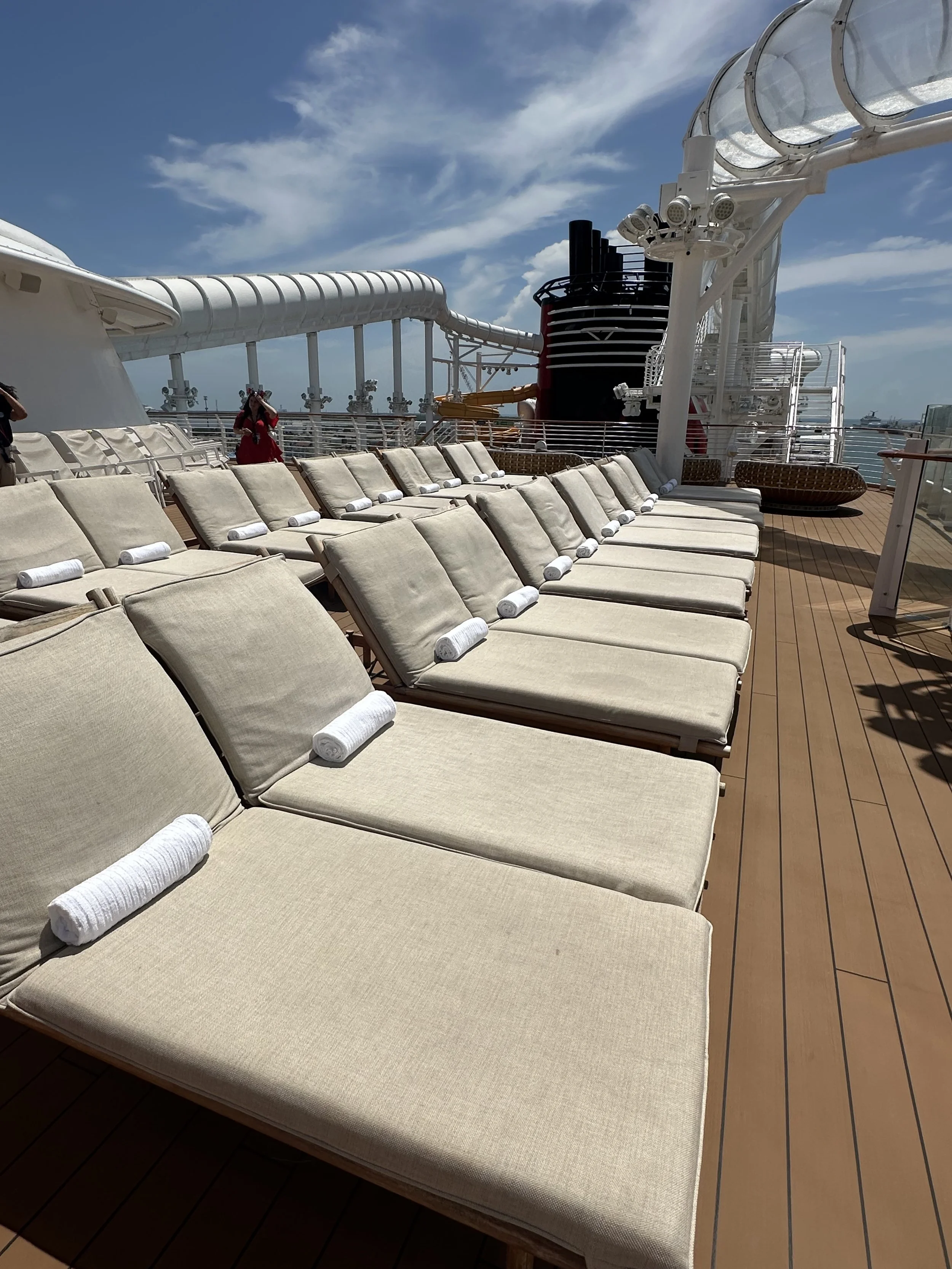 a row of beige pool chairs