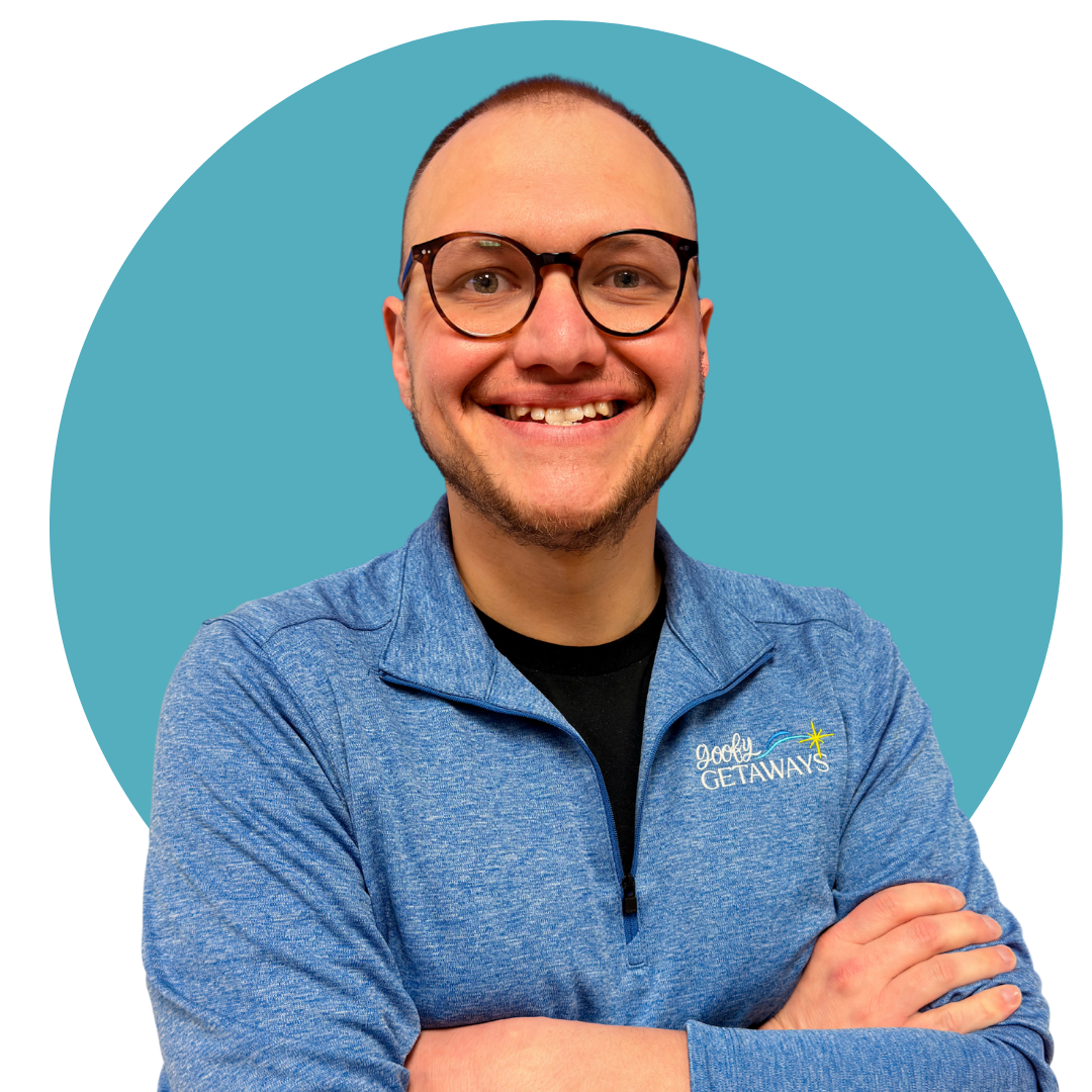 man wearing glasses and a blue quarter zip pullover