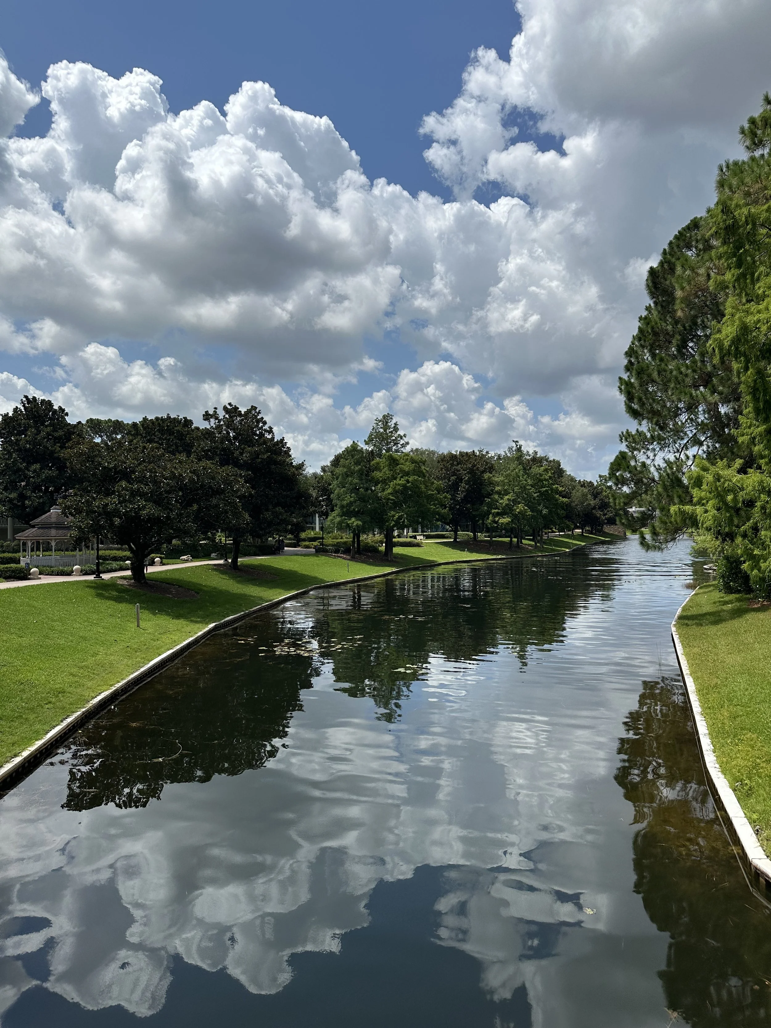 a lake with a sidewalk beside it