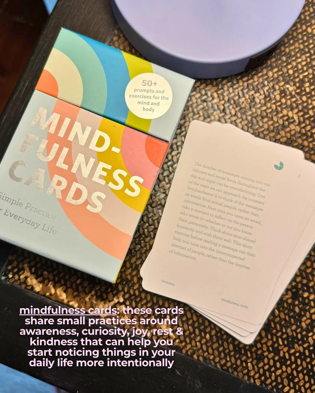 Mindfulness Cards box by Rohan Gunatillake with several cards fanned out on a woven placemat