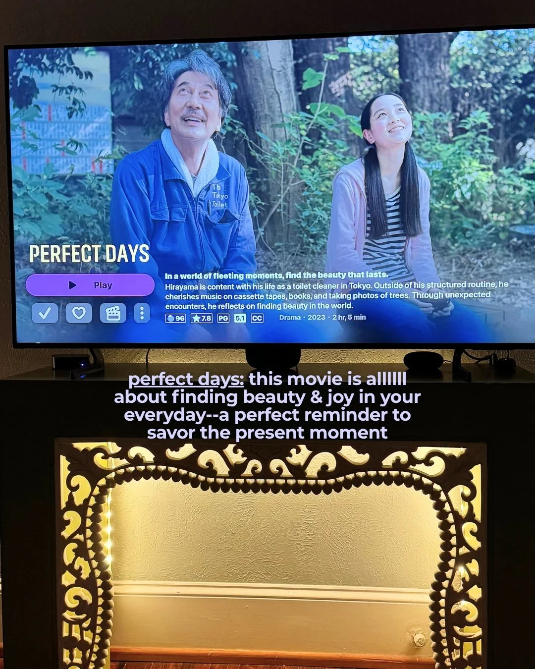 TV screen showing the movie Perfect Days above a lit-up decorative cabinet